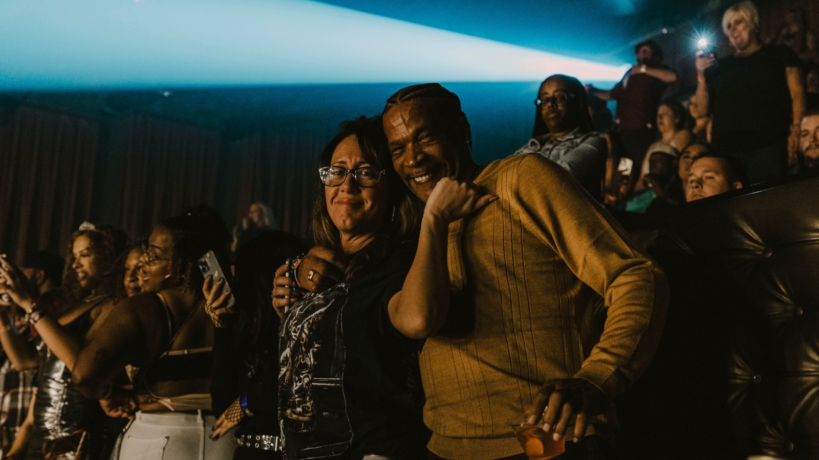 Two people facing the camera and enjoying an event 