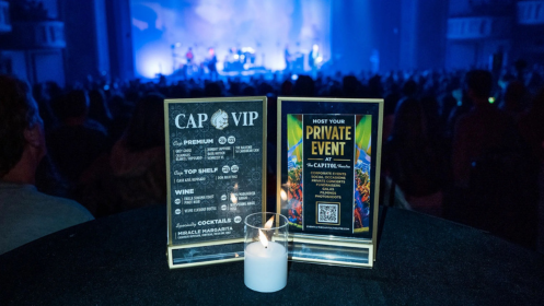 The cap VIP and private events signage on a cocktail table