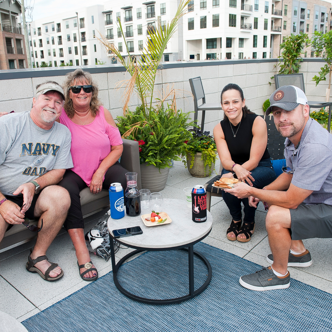 A group of friends sitting on a couch in the VIP club.