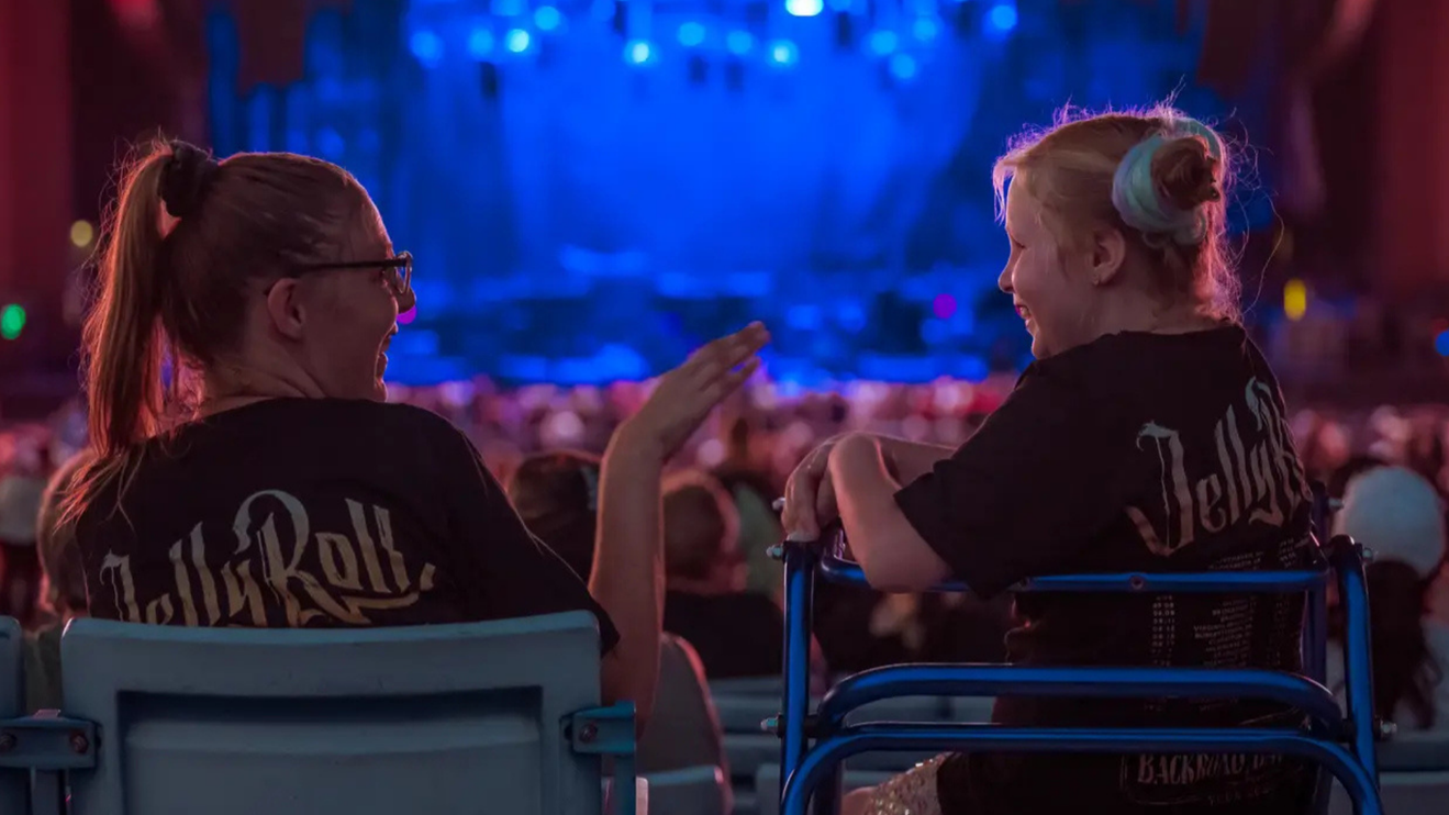 Two people facing each other in a seating area. 