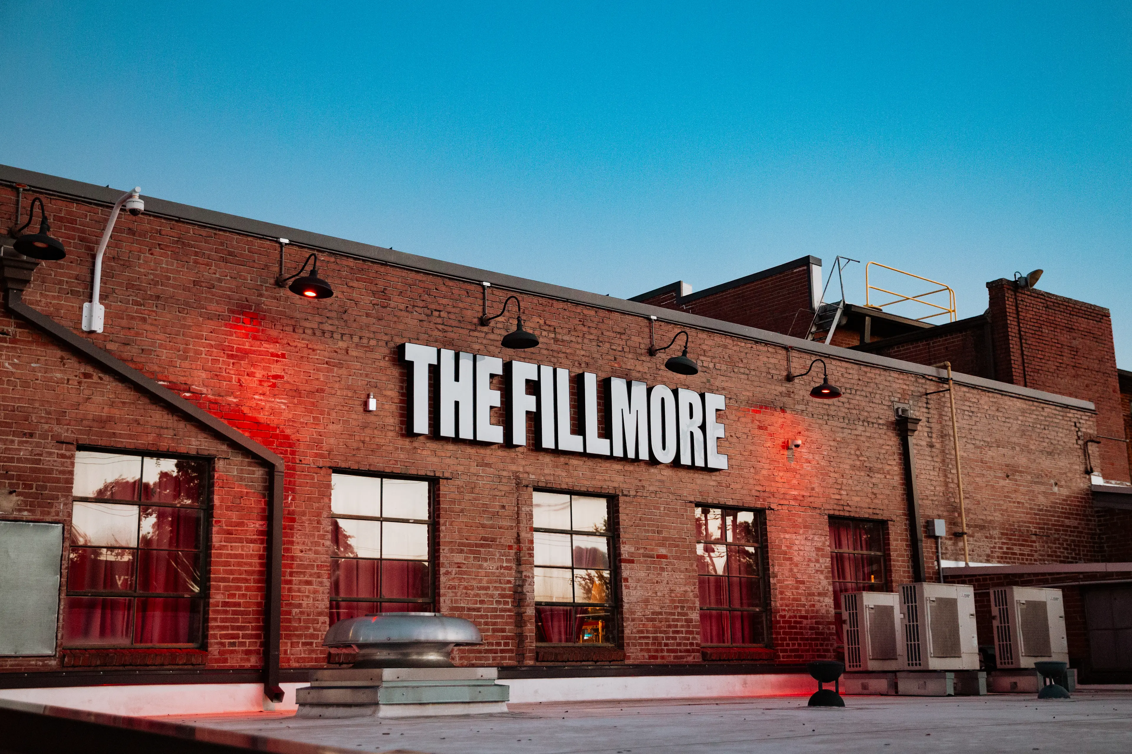 Close up photo of The Fillmore Charlotte logo and brick building. 