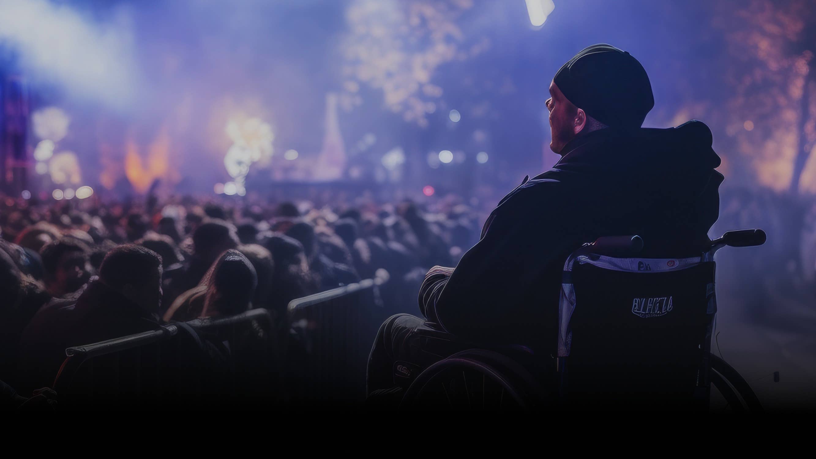 A person sitting in a wheelchair facing the stage