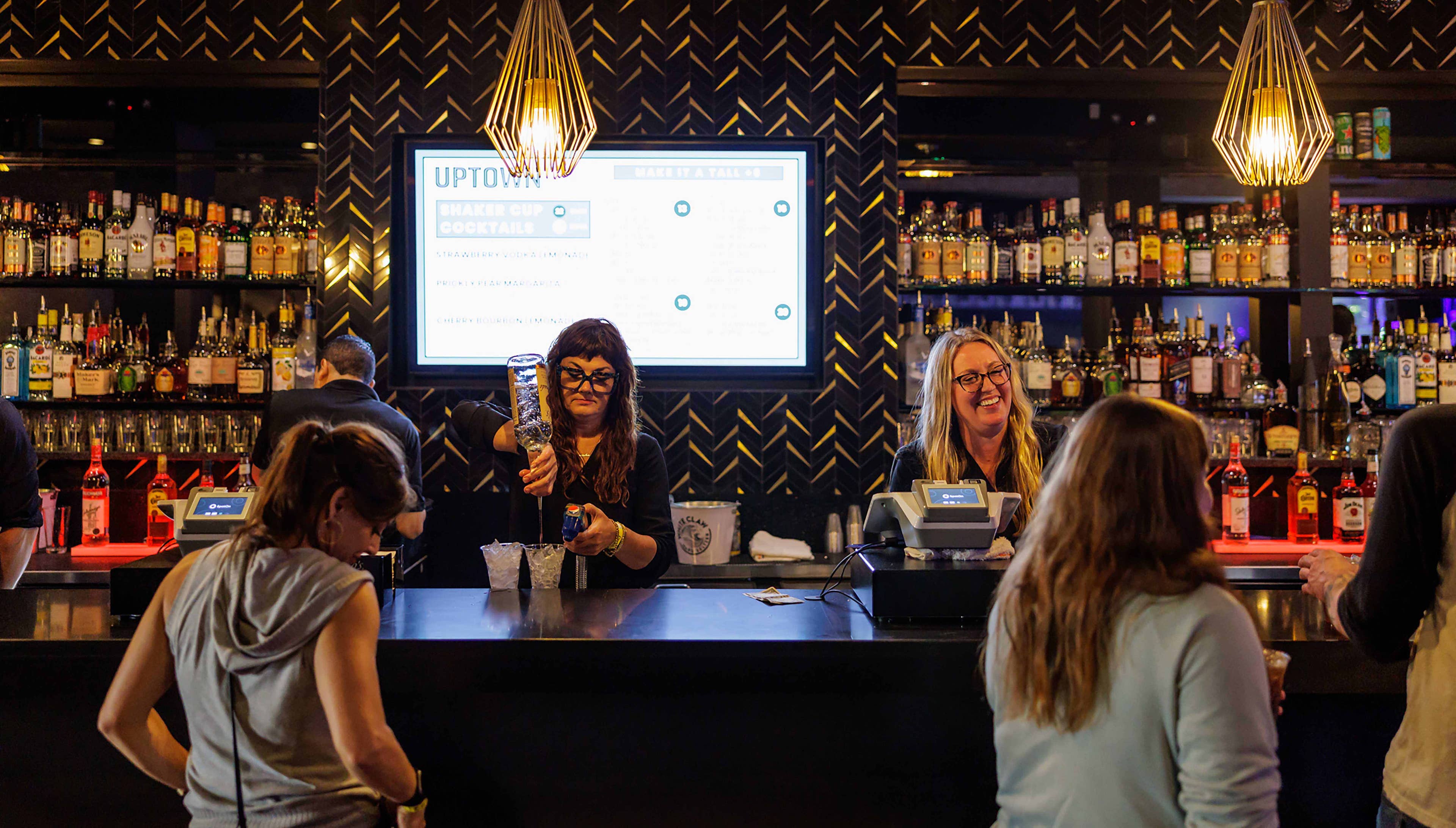 A bartender pouring a drink