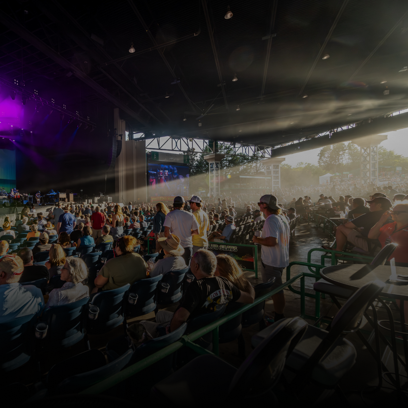 Fans sitting in seats at a concert venue