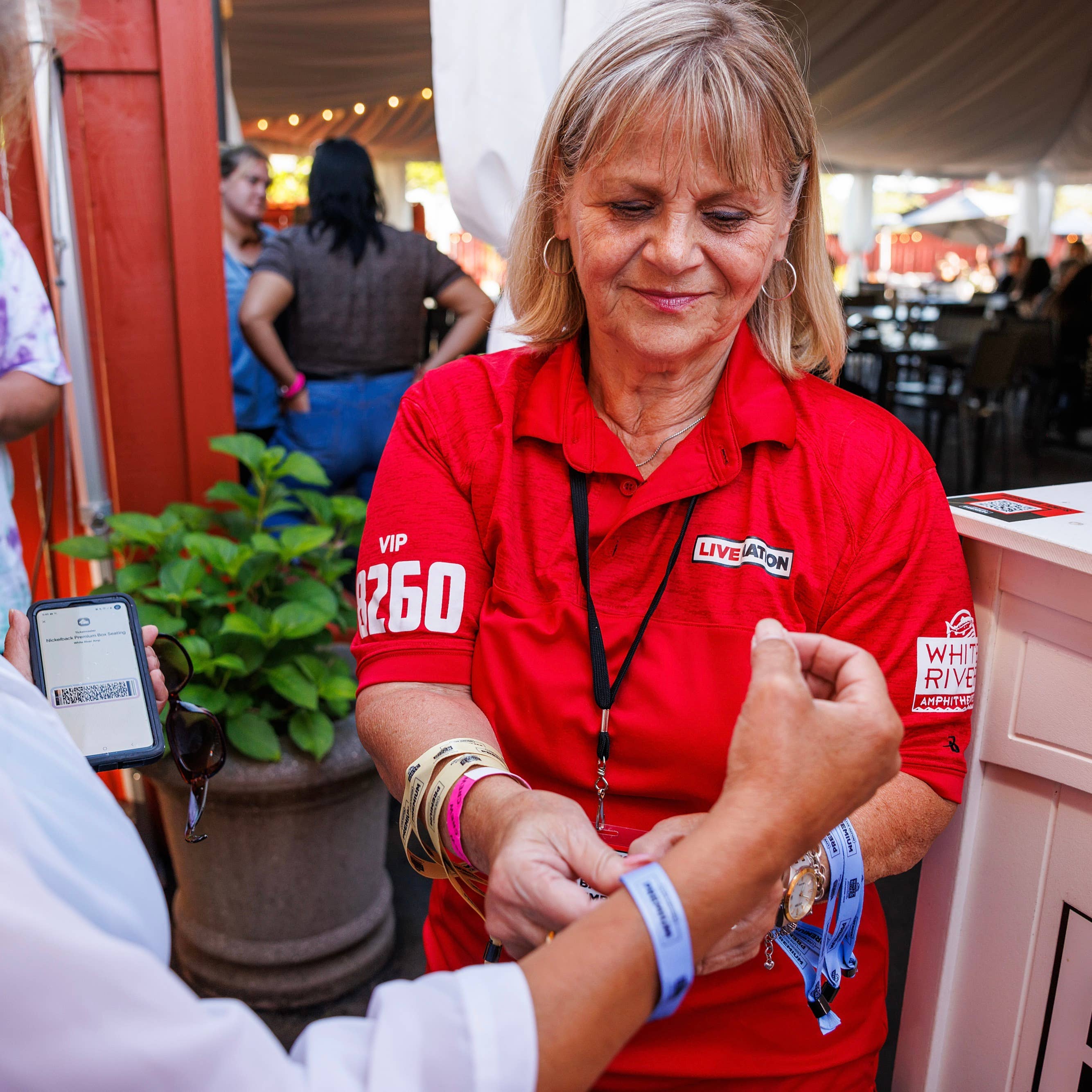 an employee putting a bracelet on someone