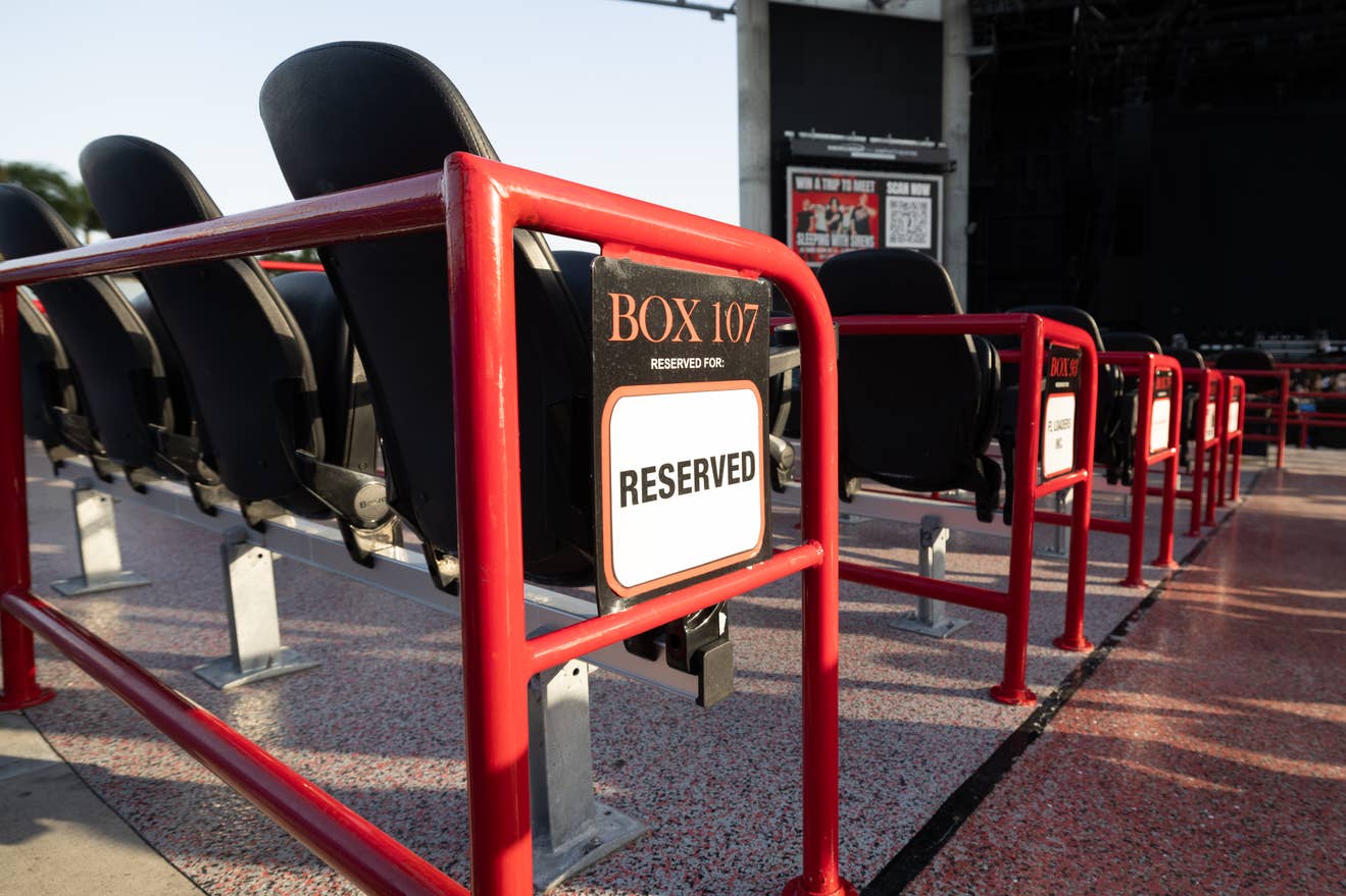 A row of empty seats with the Reserved seating sign