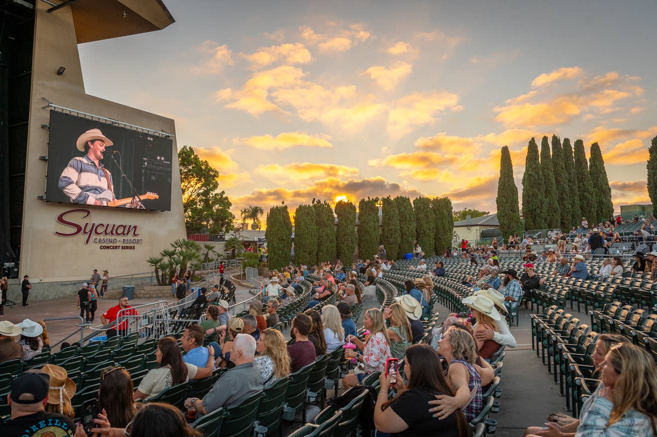 Shot of North Island Credit Union Amphitheatre bowl seating area with orange sunset in the background