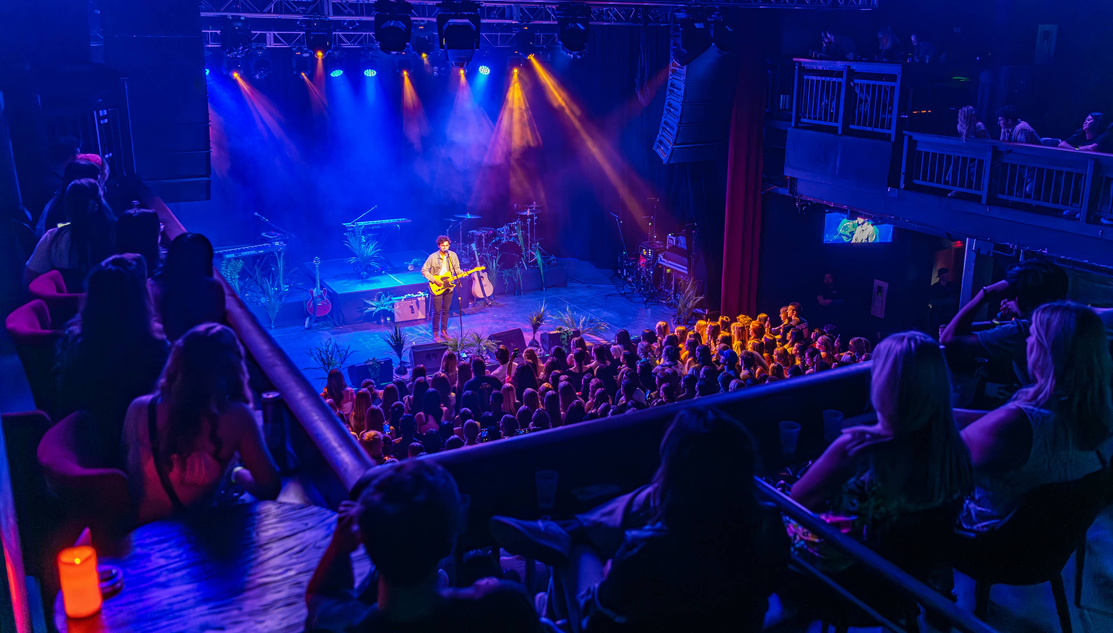 People watching a show at The Depot from the balcony