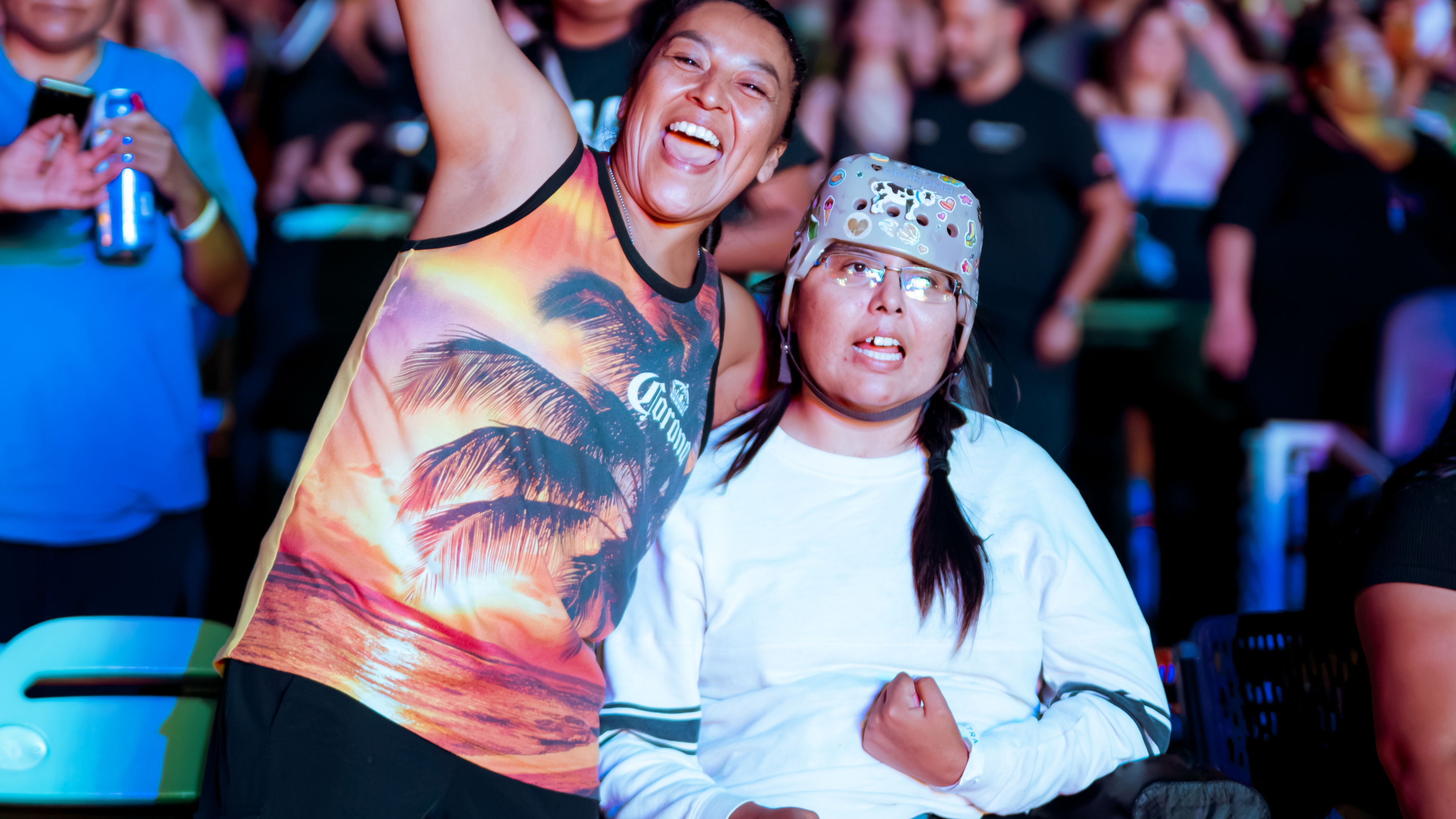 Two fans enjoying the show, one seated in a wheelchair