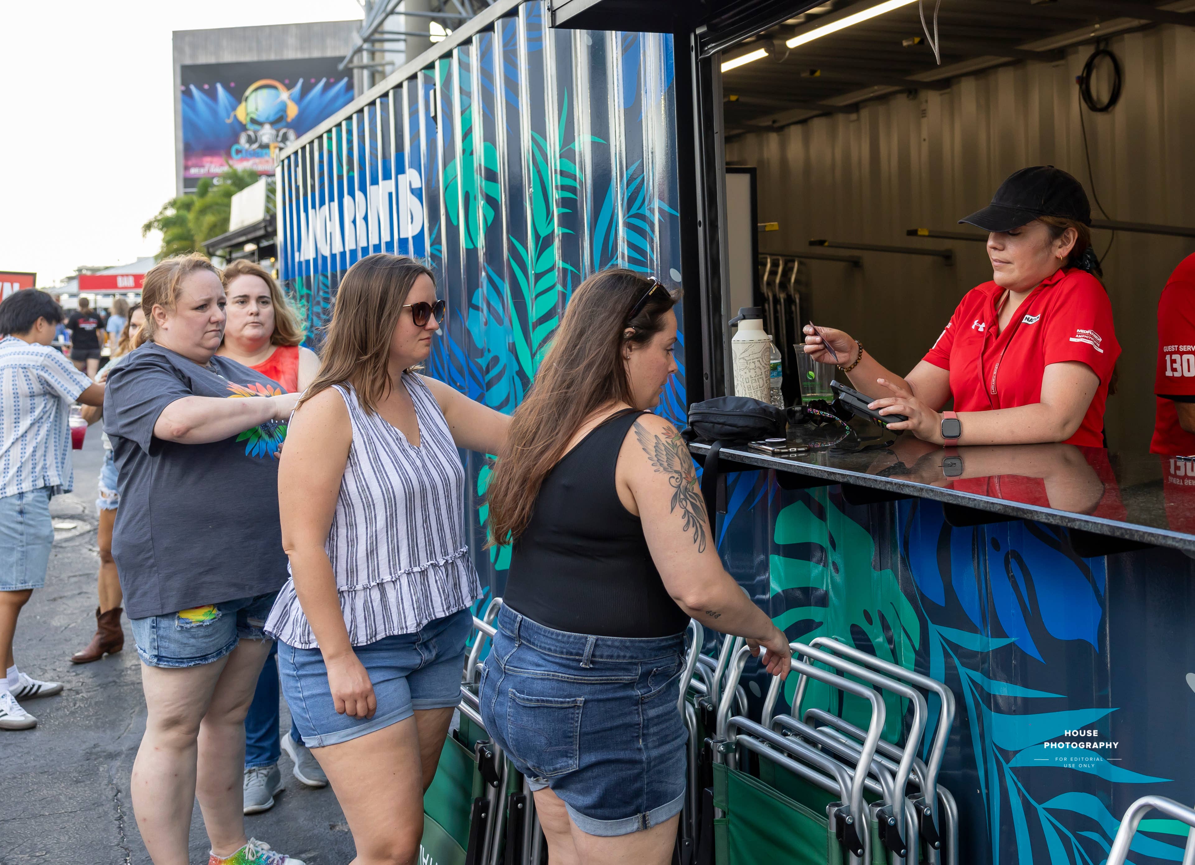 A line of people reserving a Lawn Chair.