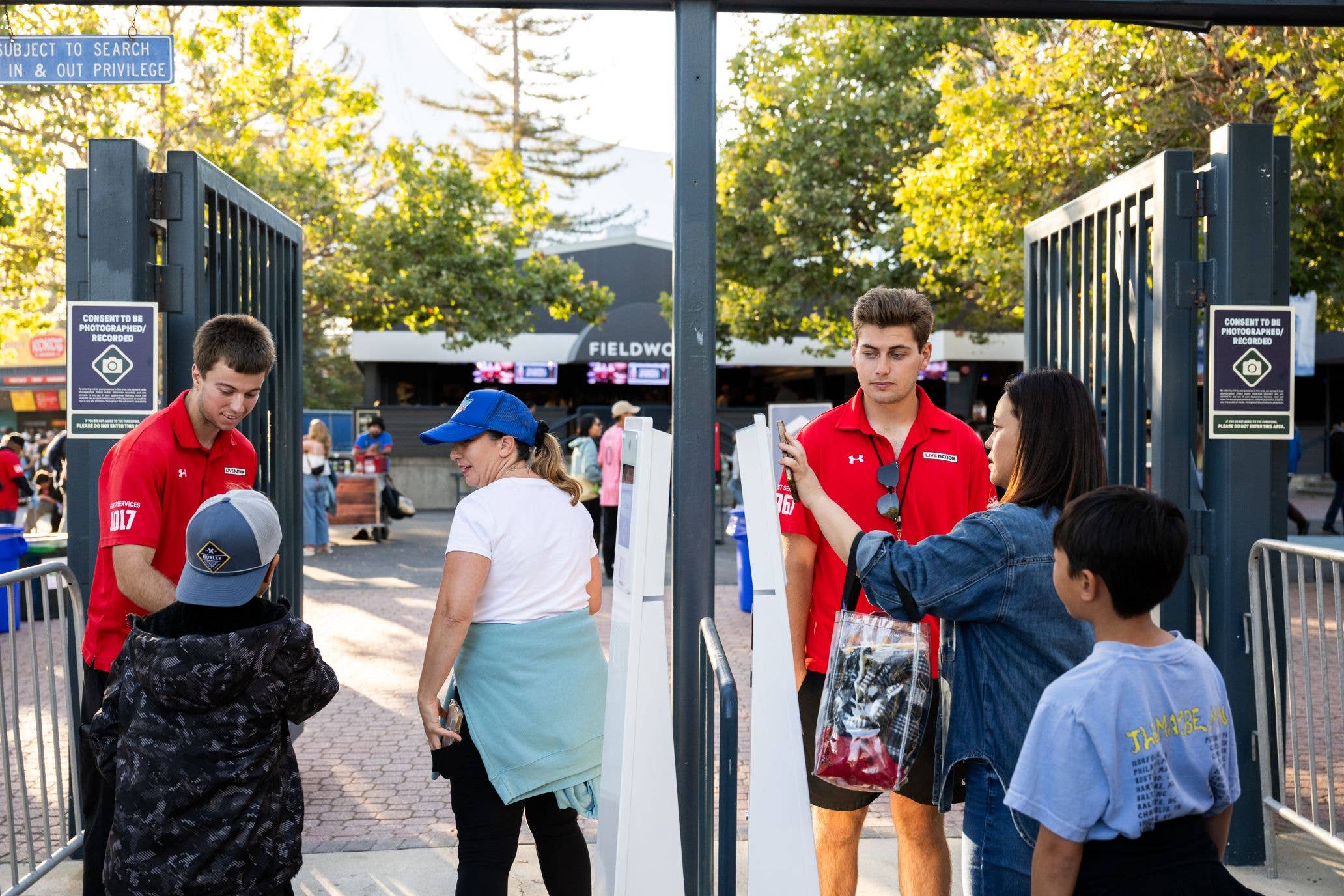 Two employees are seen scanning fans tickets as they enter the front gates of Shoreline Amphitheatre