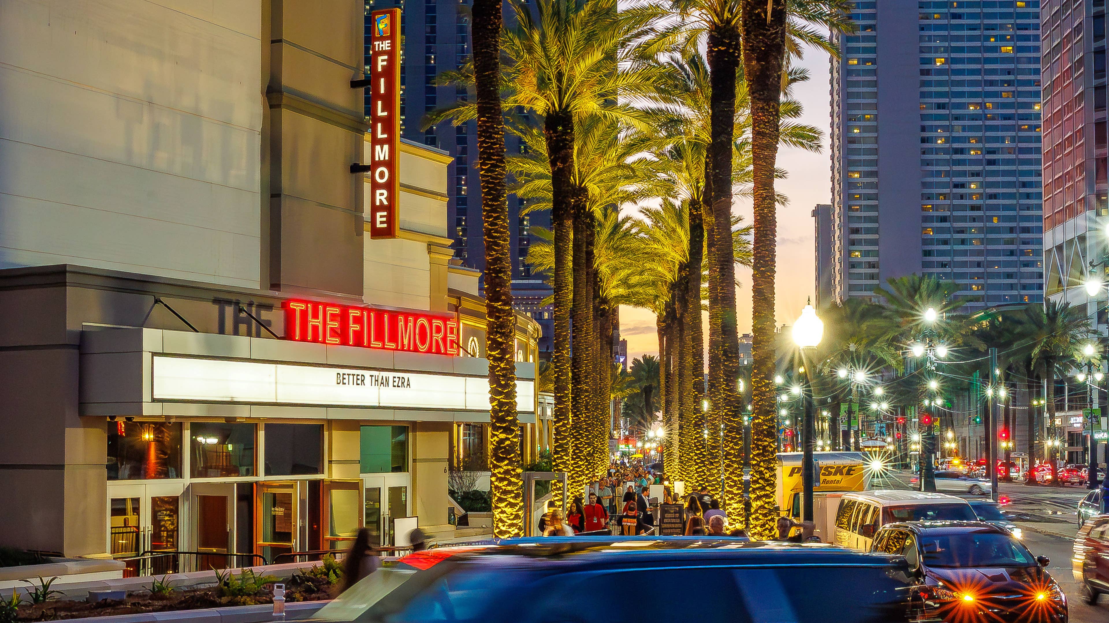 An exterior view of The Fillmore New Orleans with lights and cars passing