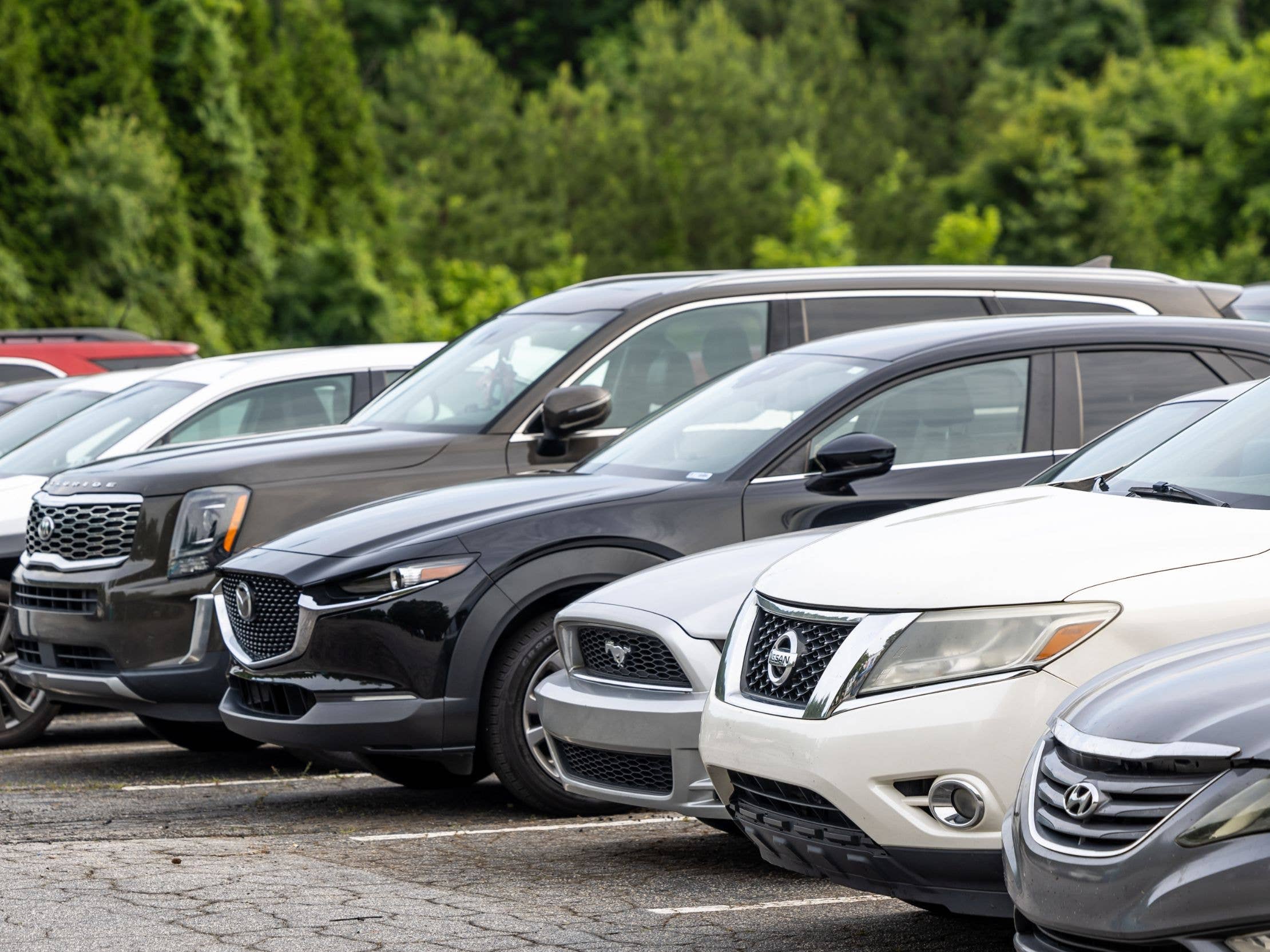 A row of cars parked in a lot