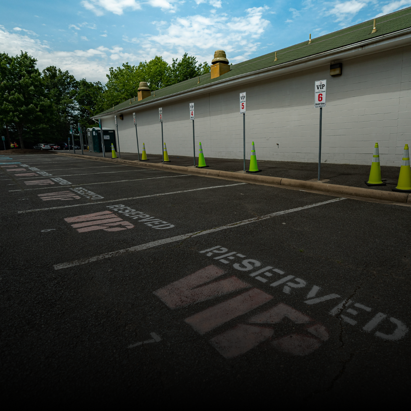 An empty parking lot with the spaces marked Reserved VIP at Xfinity Theatre