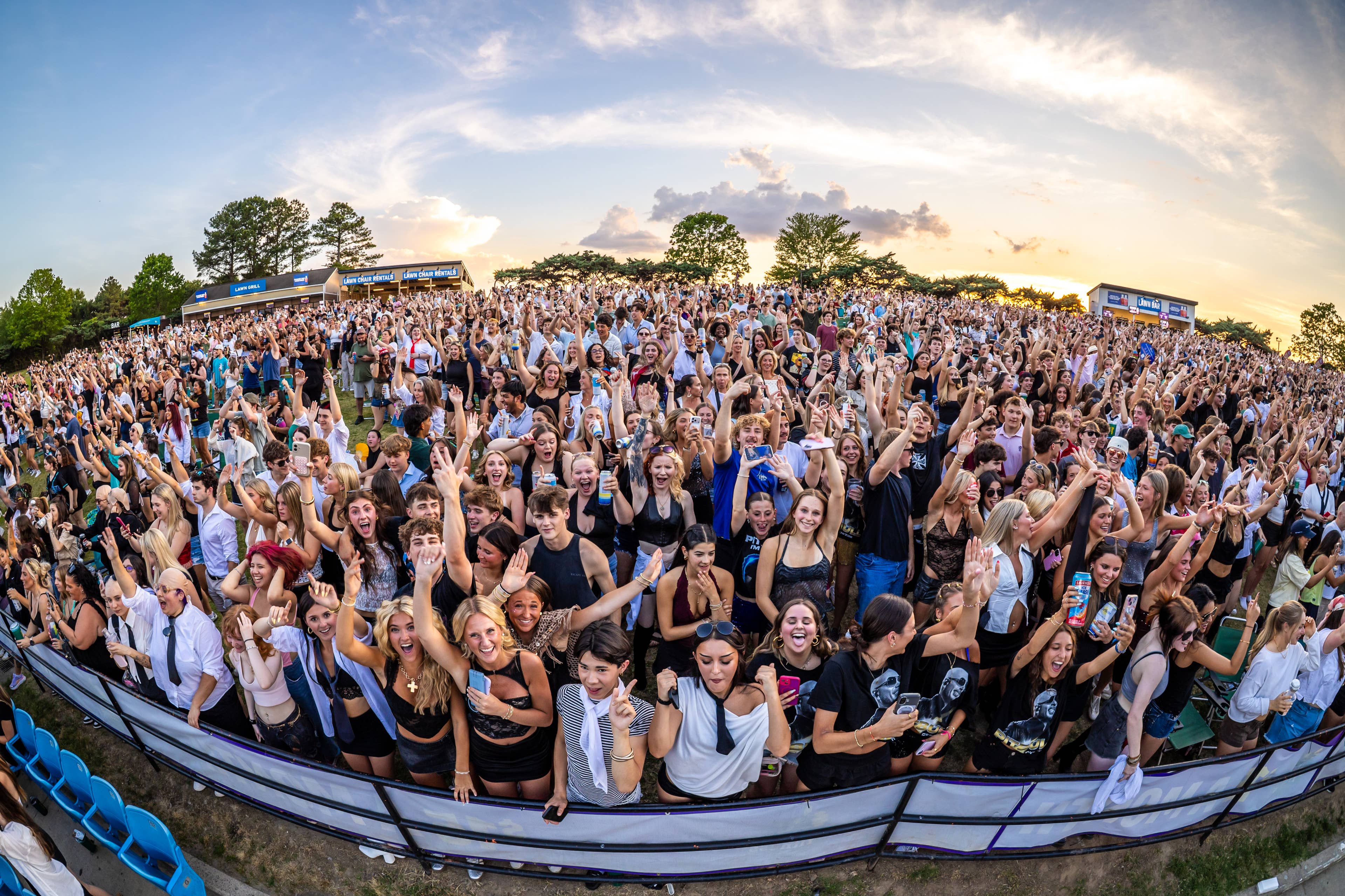 Live Nation presents Pitbull at Truliant Amphitheater in Charlotte, North Carolina on May 20, 2026. The photo shows a group of fans in the lawn.