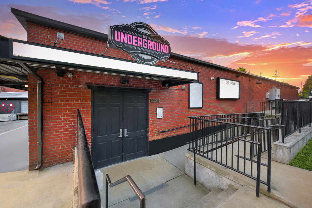 A photo of The Underground logo, doors and brick building. 