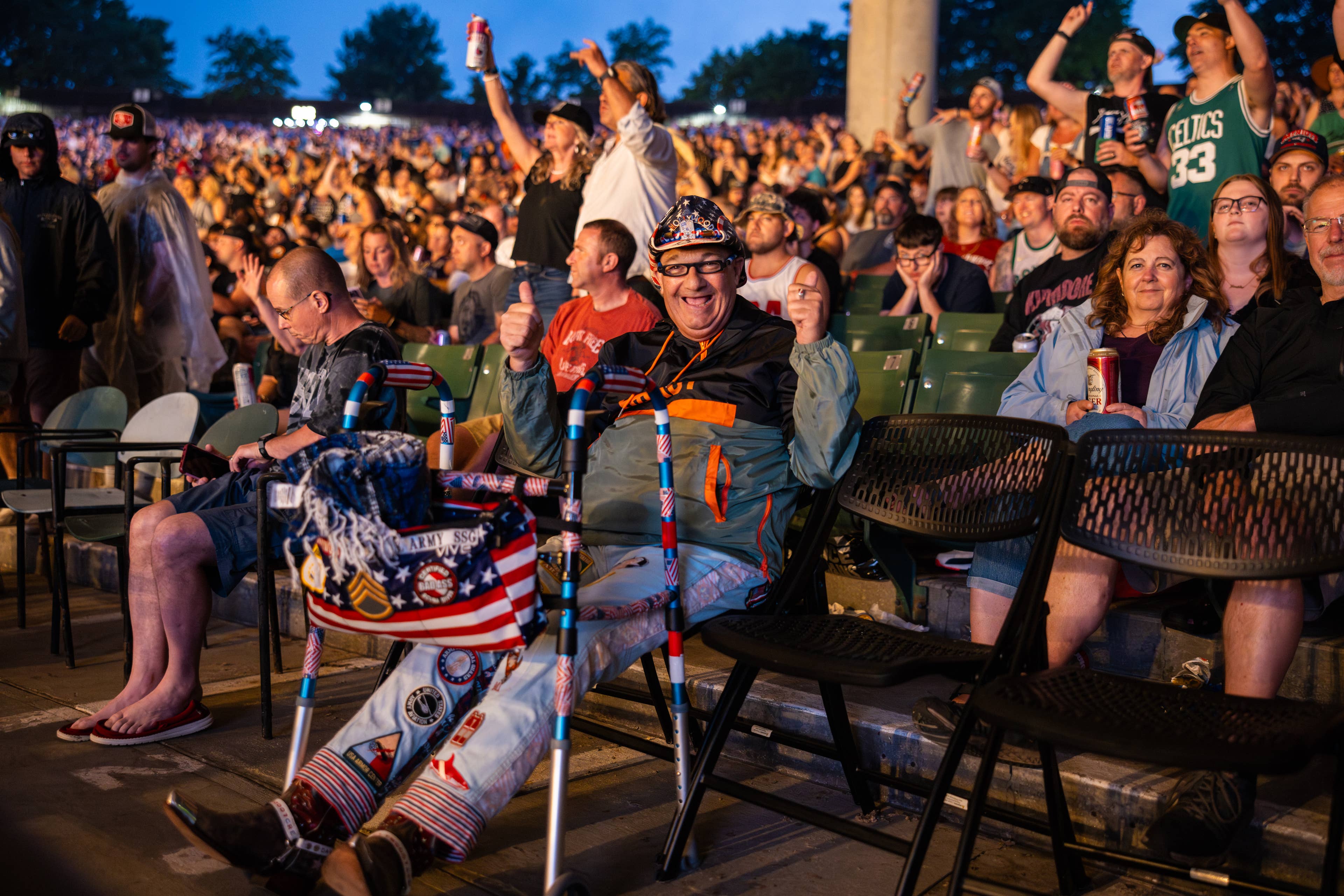 a fan in accessible seating giving a thumbs up