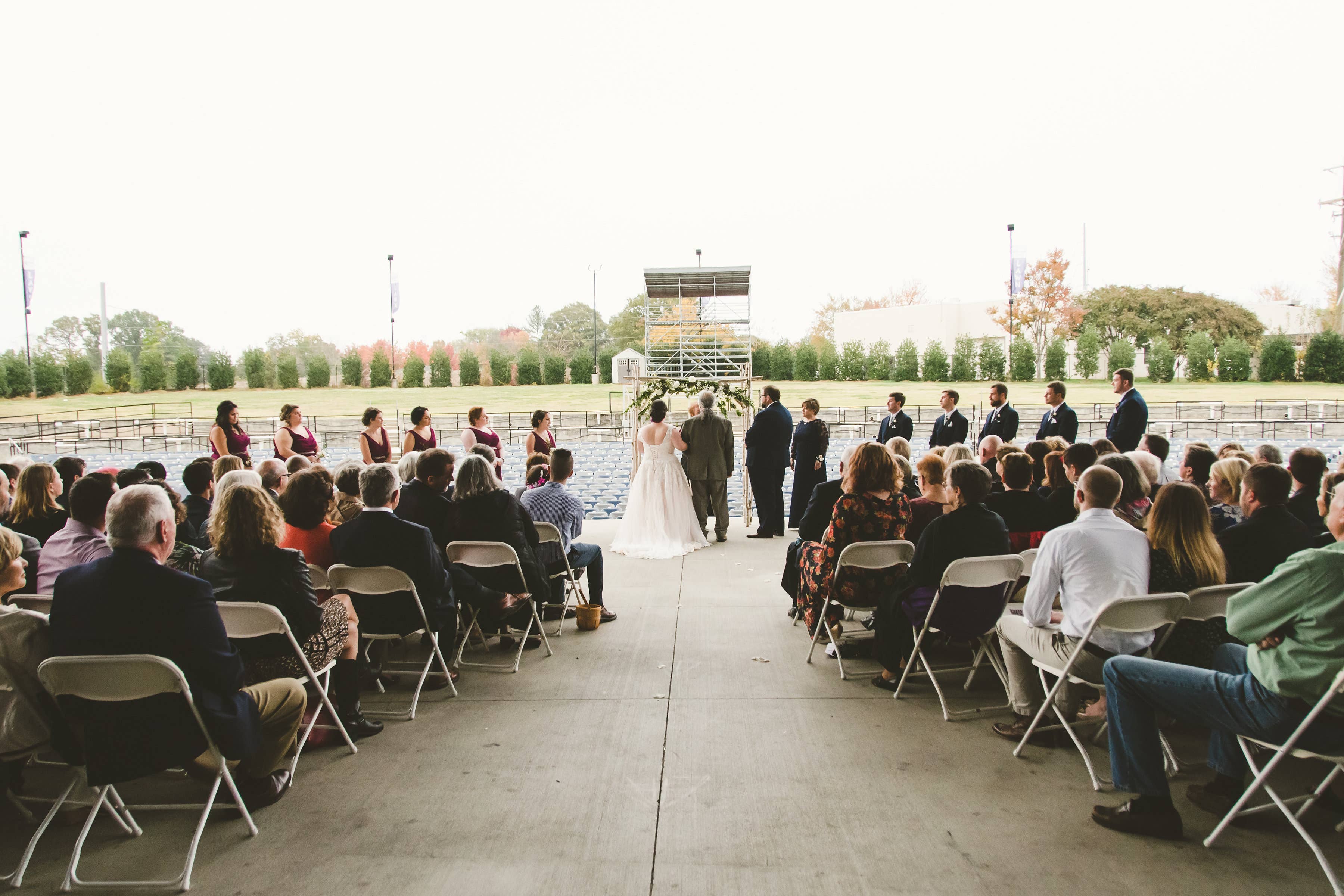 A photo of a wedding happening on the Skyla Credit Union Amphitheatre stage.