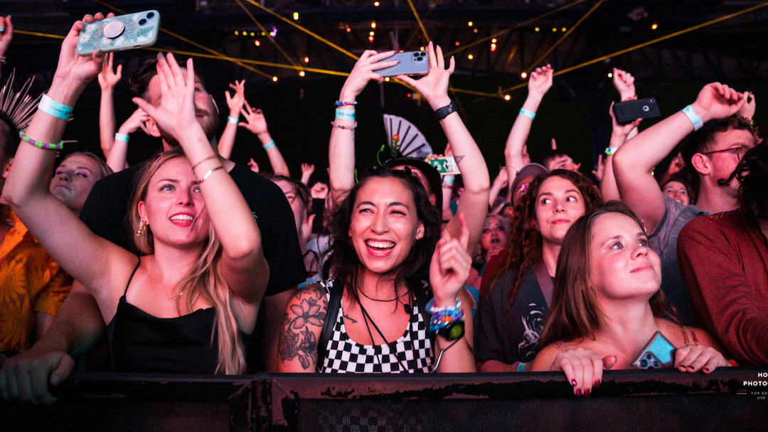 Fans standing in front of the barricade and smiling