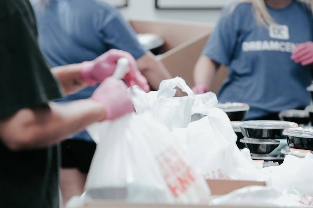 A close up of people working in a soup kitchen
