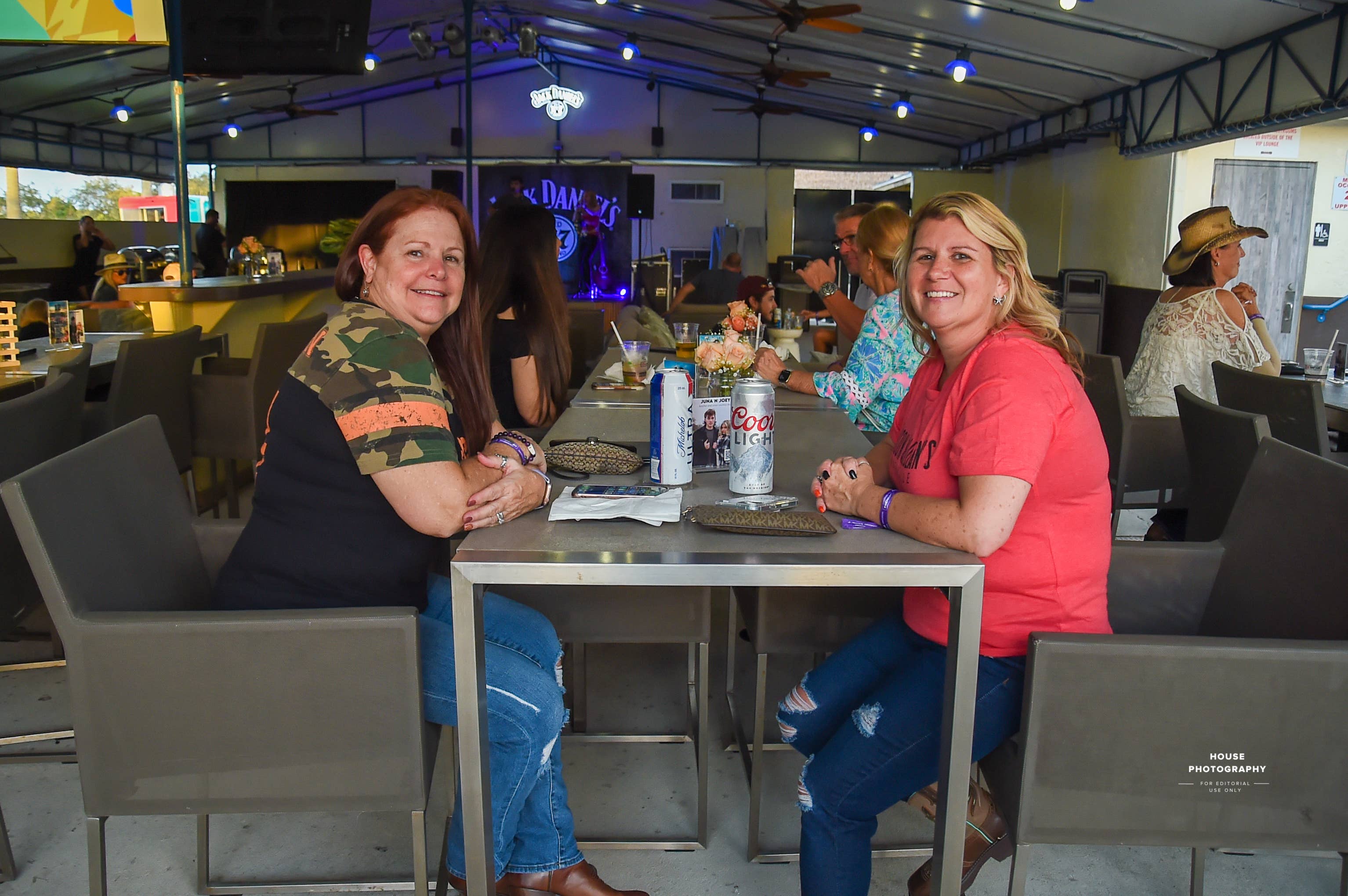 Two women sitting at a table looking at the camera