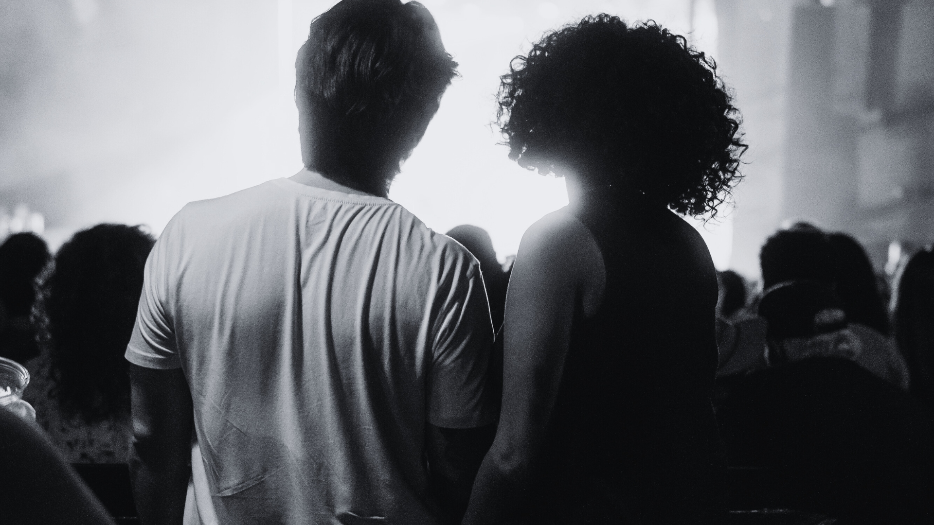 An image of two people facing forward in the crowd