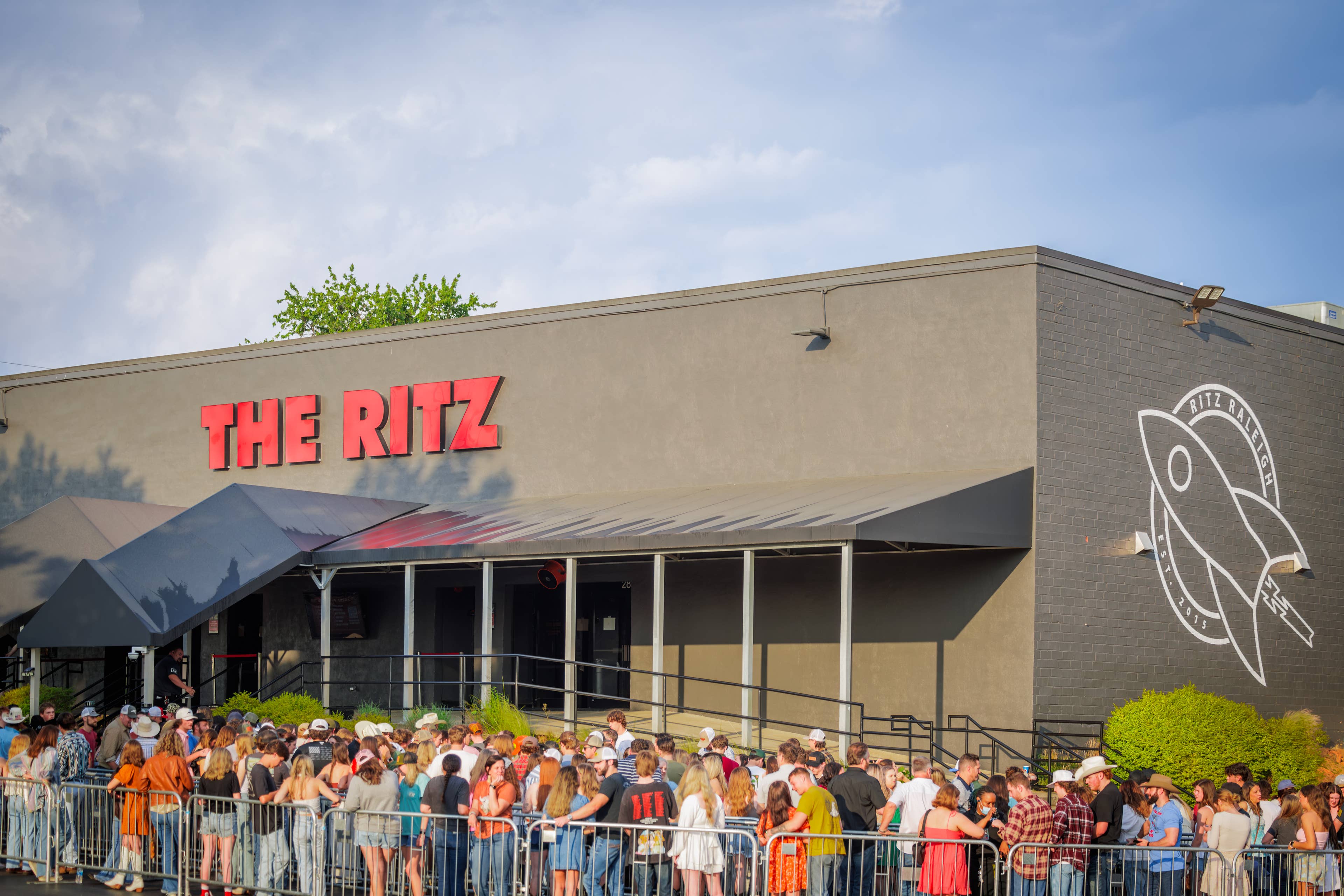 An image of a gray building with red sign that says The Ritz.