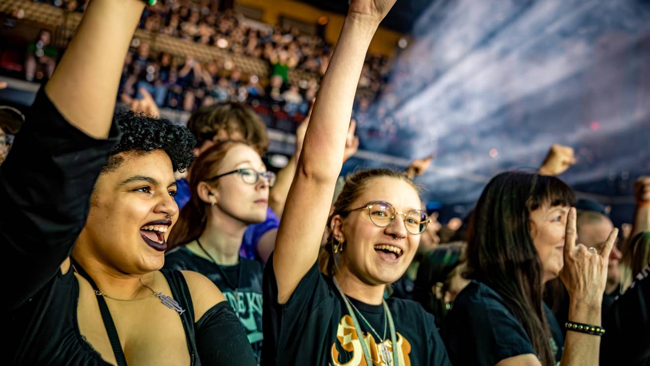 Girls at a show, one smiling and looking at the camera, all having a great time it seems.