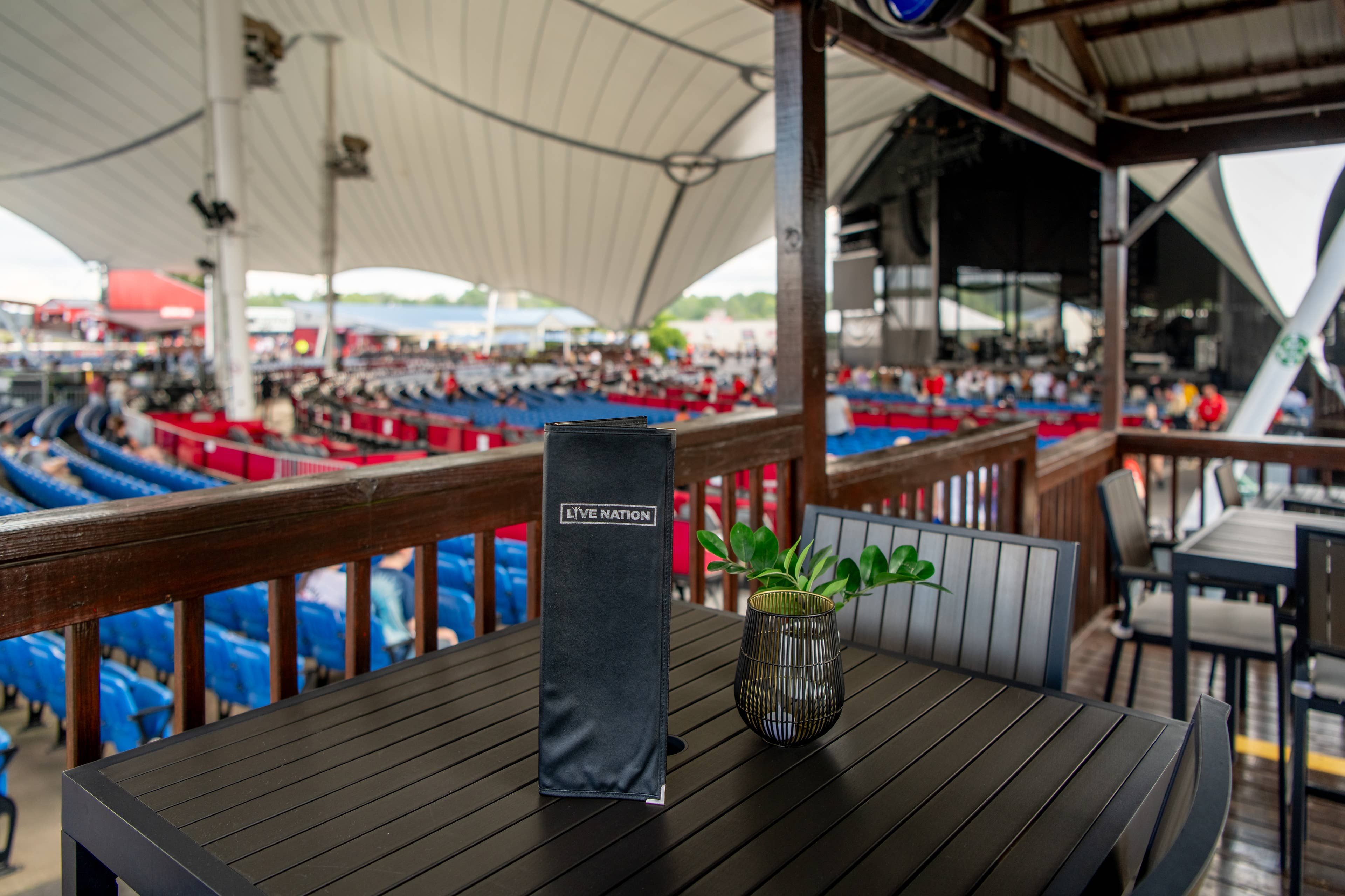 an empty VIP table with a menu and view of the stage