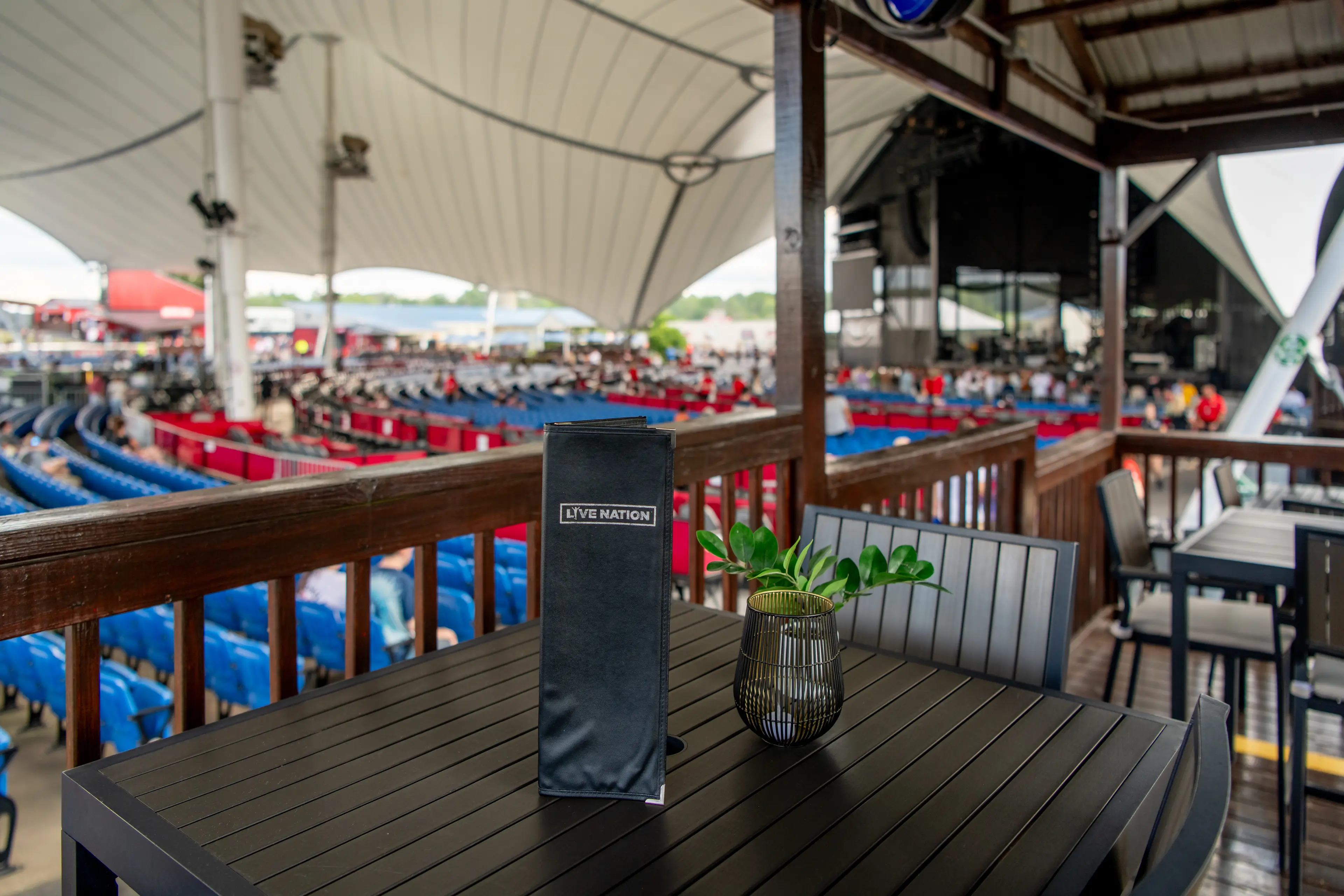 an empty VIP table with a menu and view of the stage