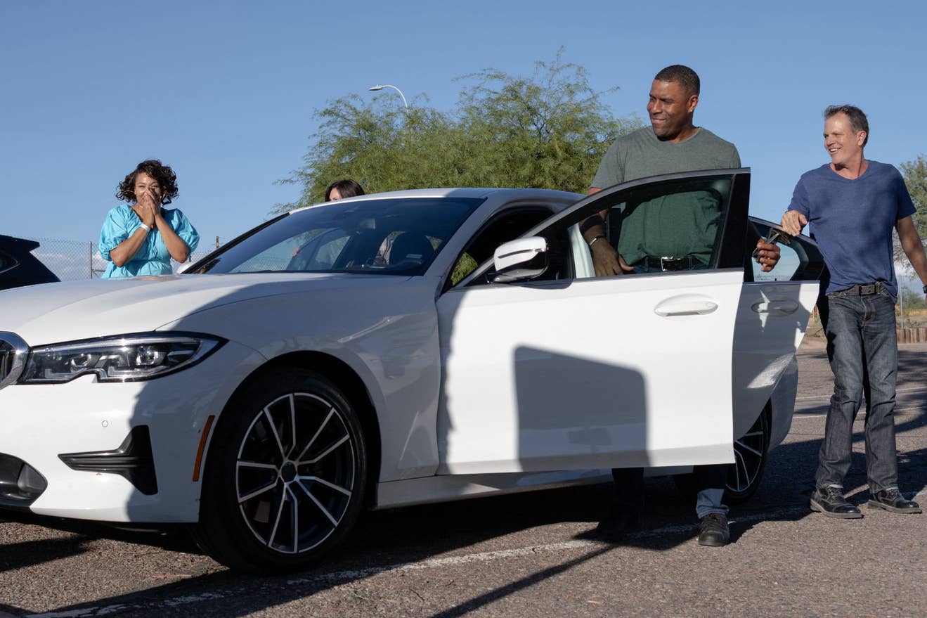 Fans get out of their car after parking.