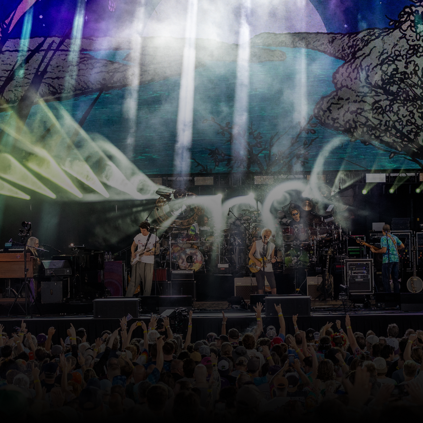 Performers on stage with lights behind them.