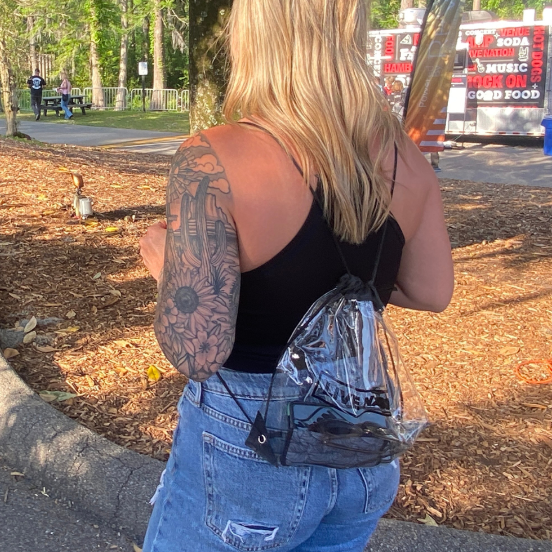 A woman wearing a venue approved clear bag.