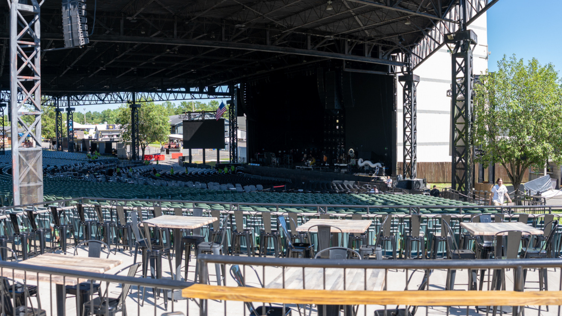 Empty Star Lake Lounge in the middle of the concourse with high-top tables and chairs and view of the stage. 