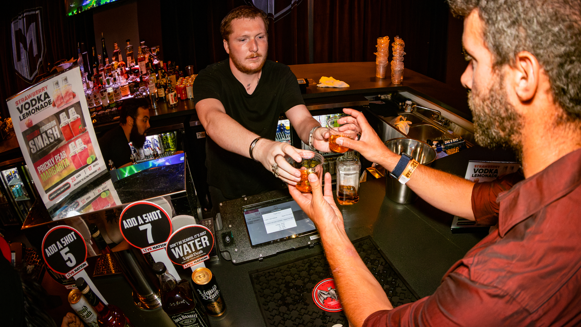 A customer buys a drink at Mercury Ballroom.