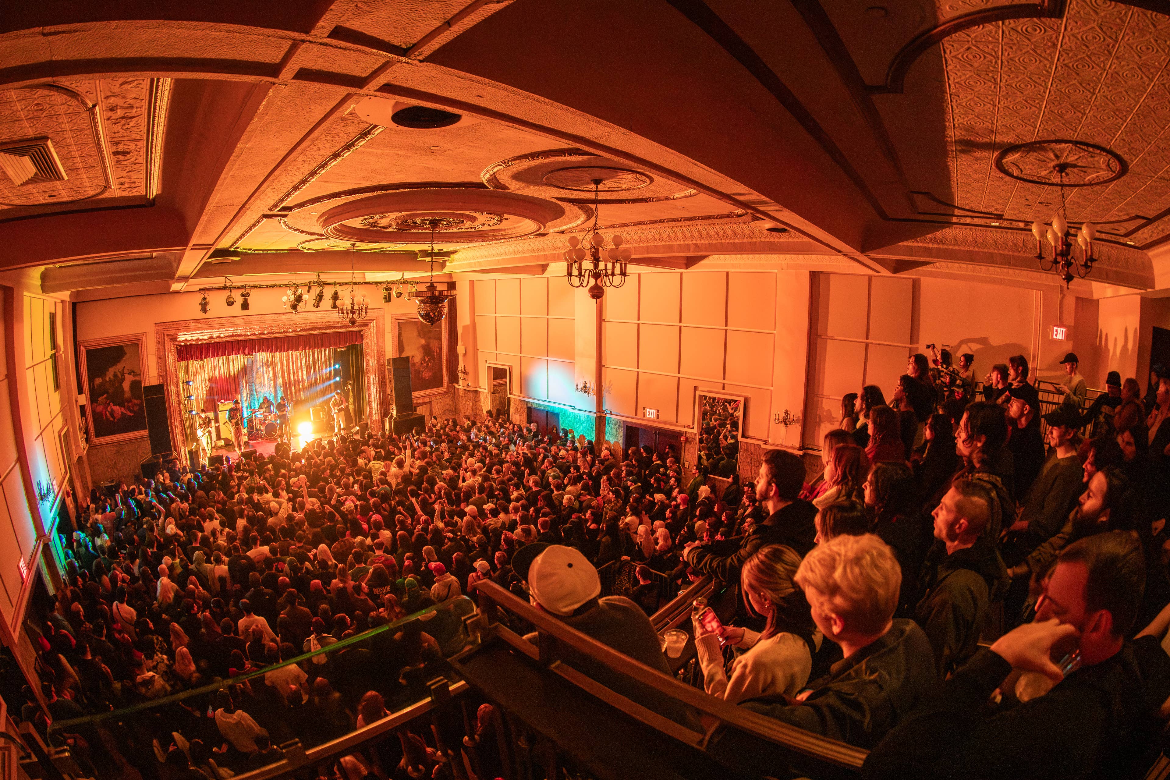 a balcony view of a concert at Warsaw showing a sold out crowd looking at Citizen band on stage