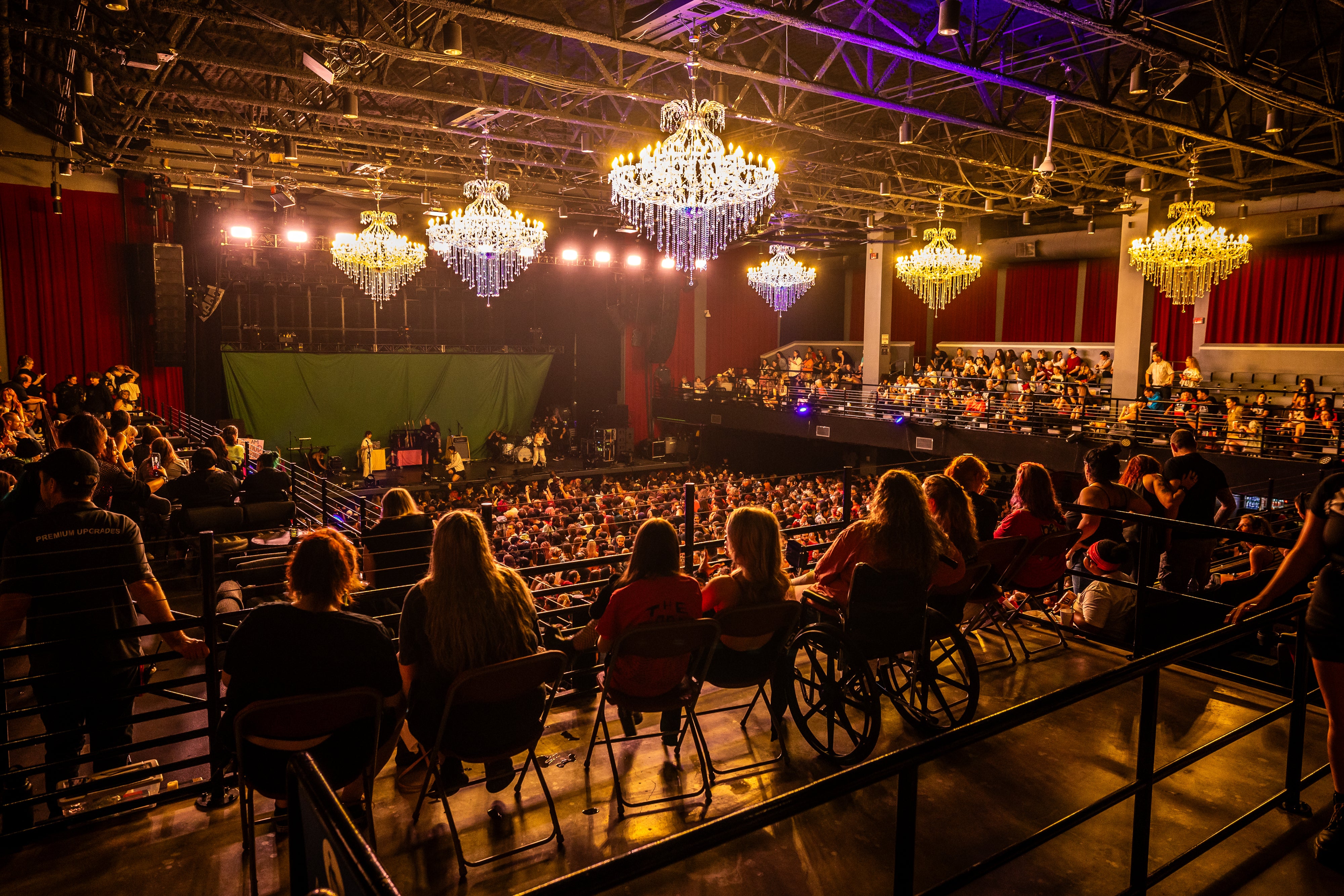 People sitting in the accessible section on the balcony of the venue.