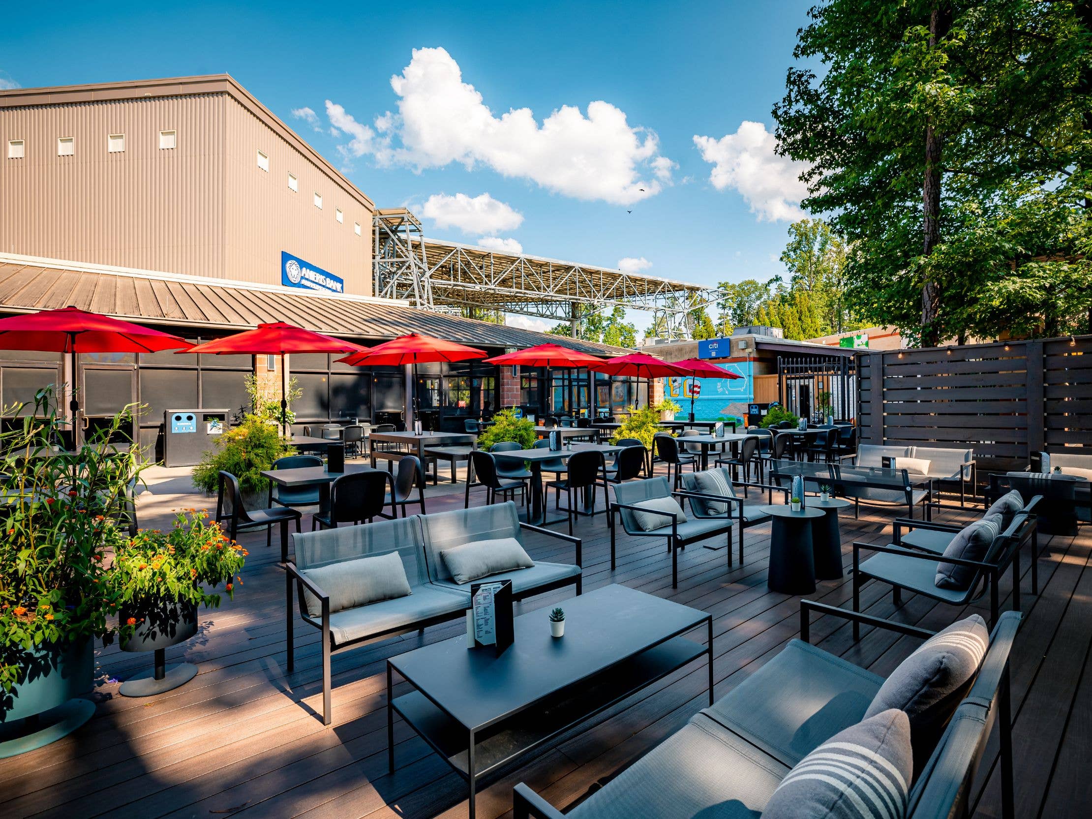 A view of The Lounge highlighting the indoor area and outdoor patio with tables, tents, and seating
