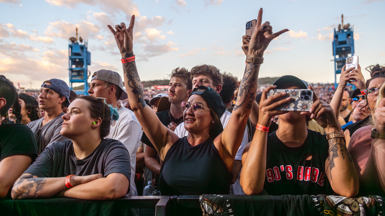 woman throwing up the horns
