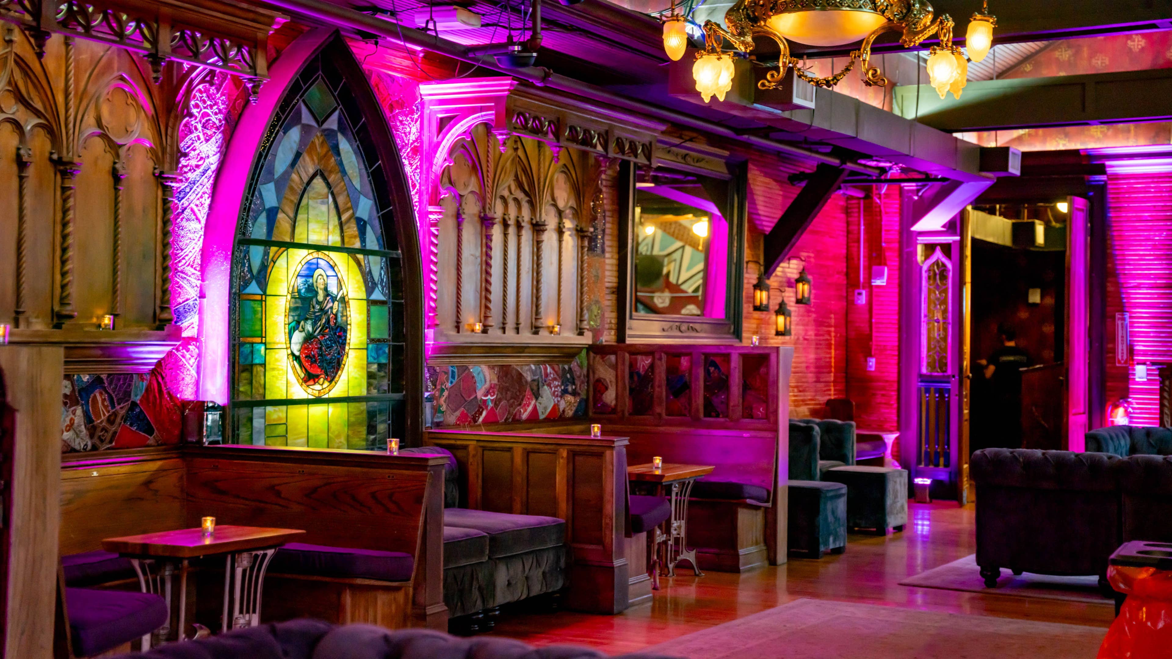 A VIP Lounge with stained glass windows and lounge seating