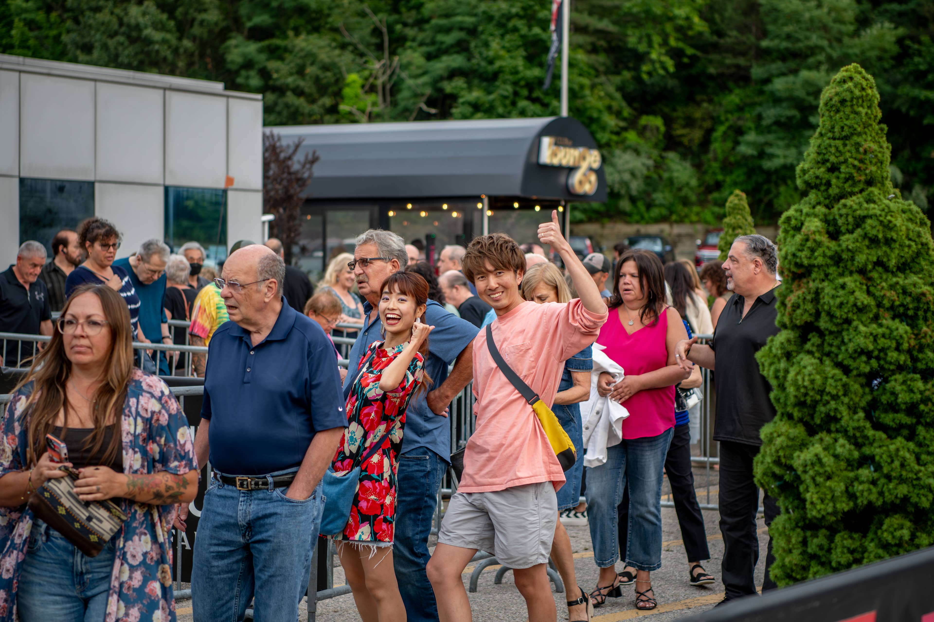 Attendees in line smiling at the camera at Flagstar at Westbury Music Fair