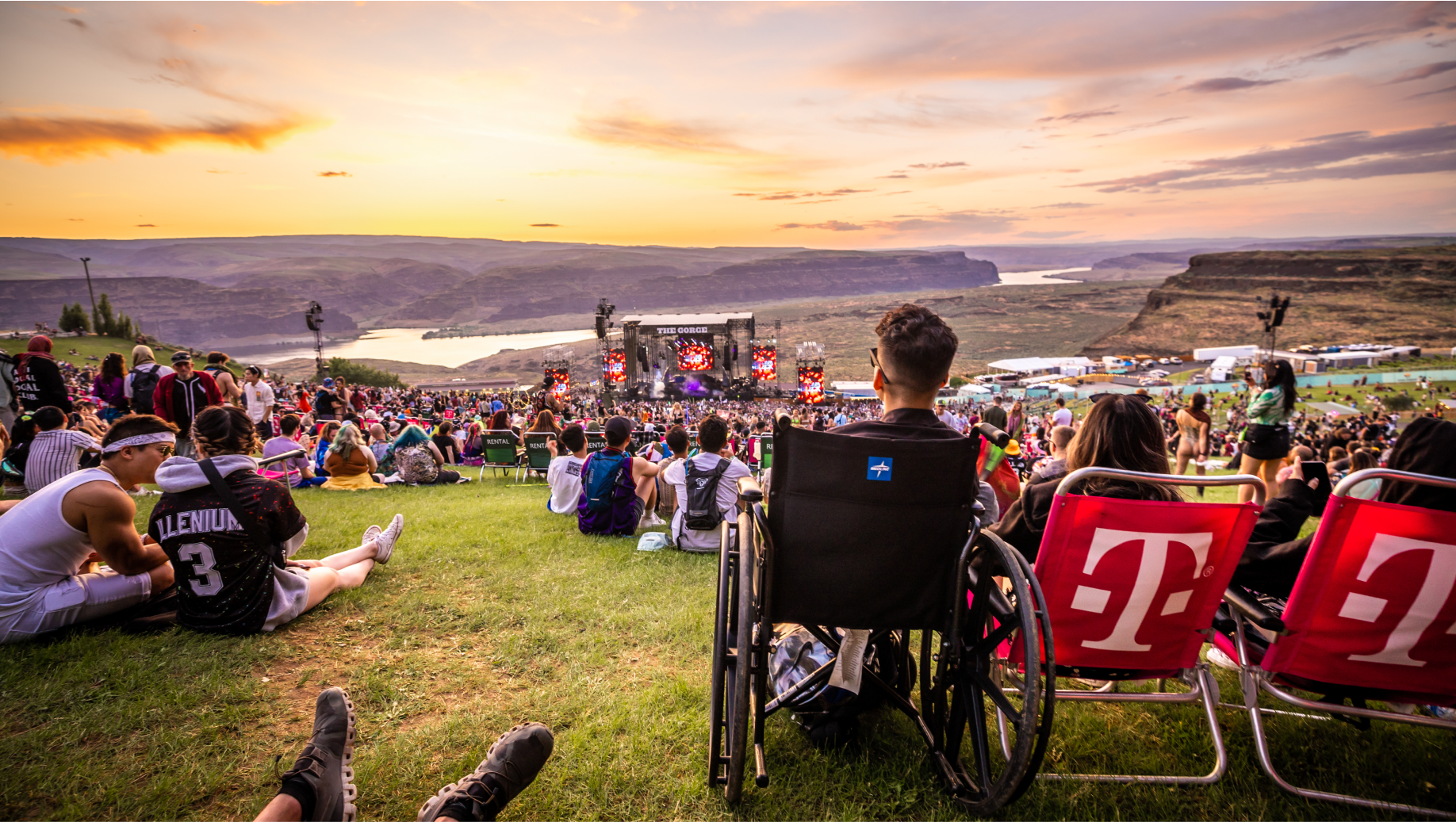 An image of a man in a wheel chair enjoying the show from the top of the lawn at The Gorge.
