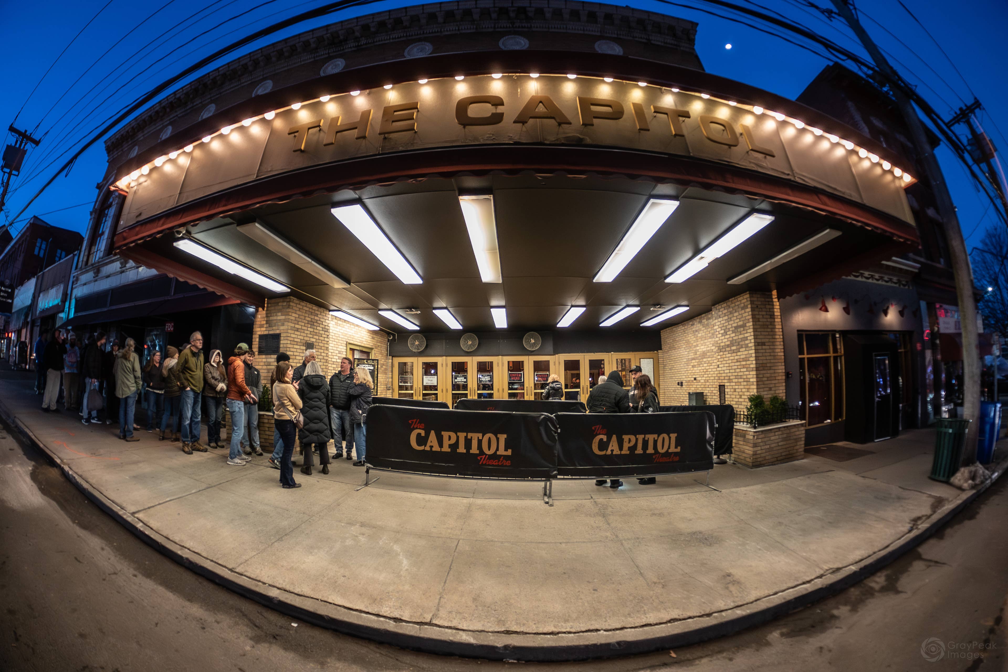 The exterior of The Capitol Theatre building with a line forming