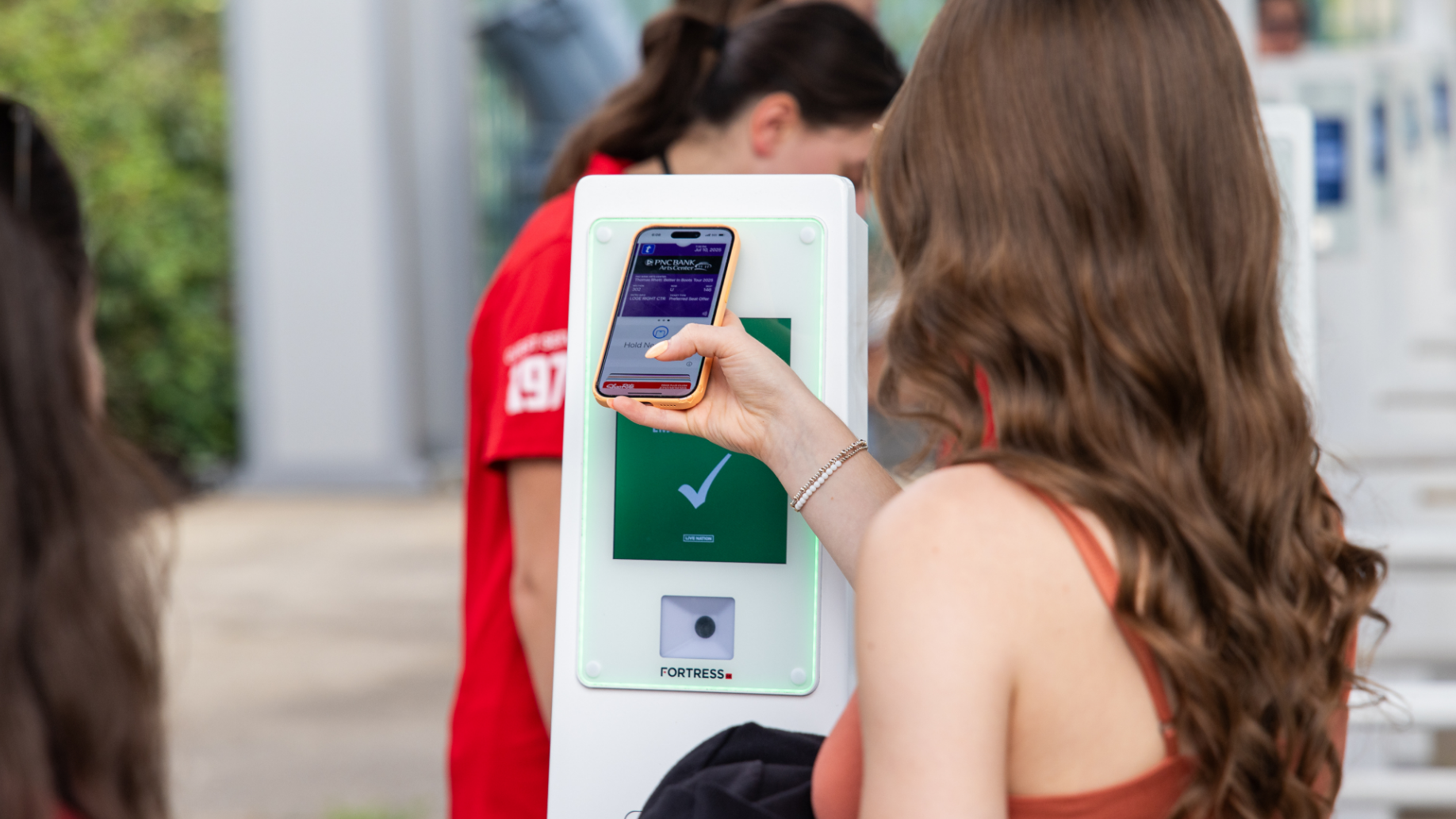 A fan scans their ticket for entry into the venue. 