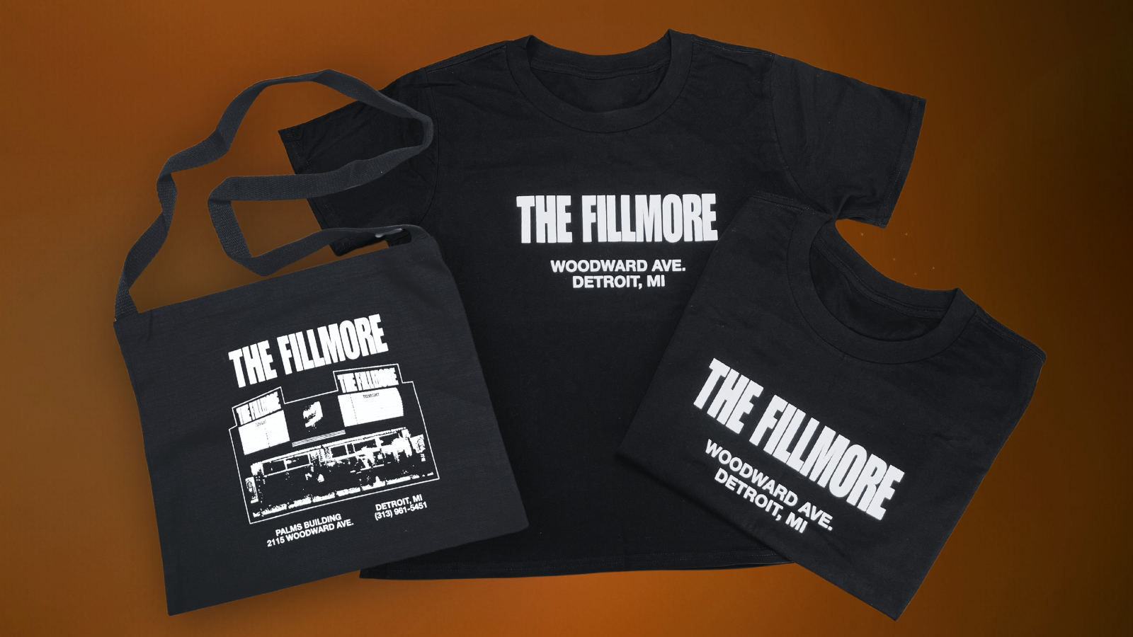 The Fillmore Detroit new merch showing two t-shirts and a tote bag, all black items with white letters.