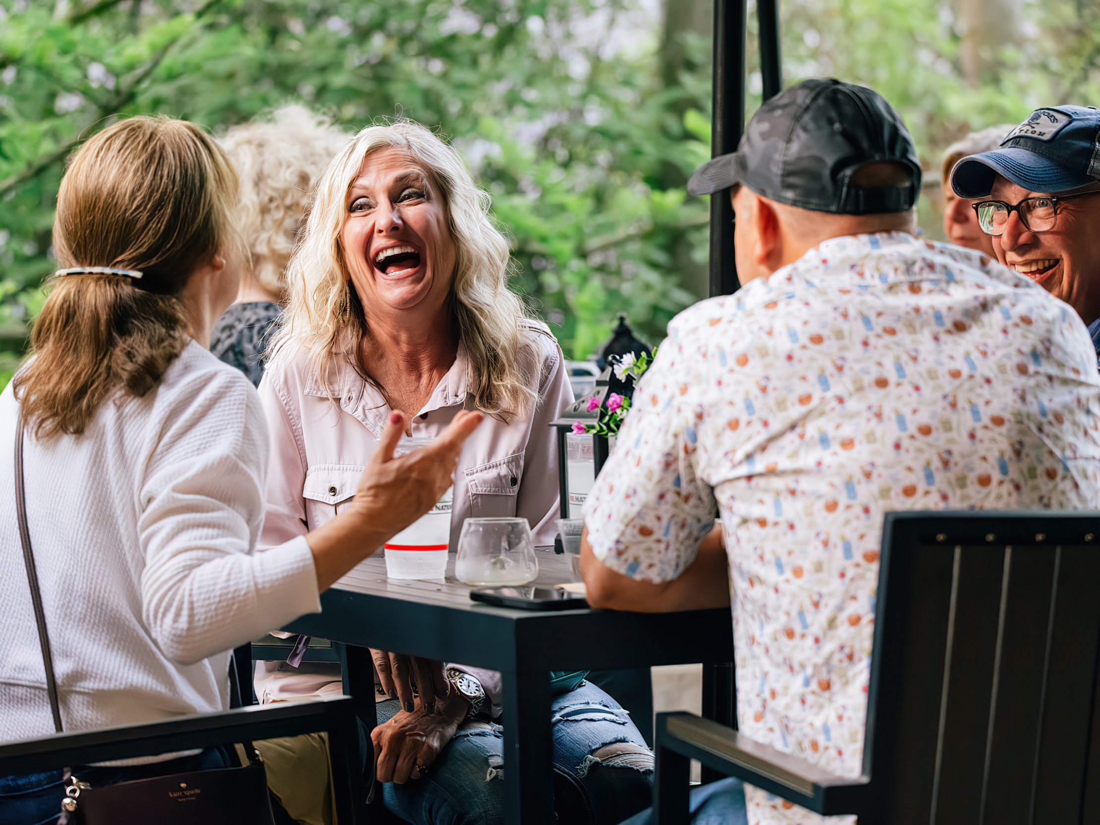 Fans sitting at a table enjoying the Huntington Club.