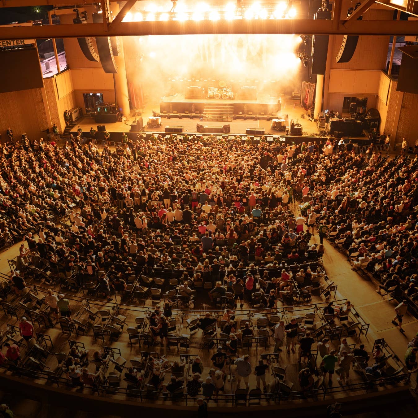 A view of a crowd facing the stage from the roof. 