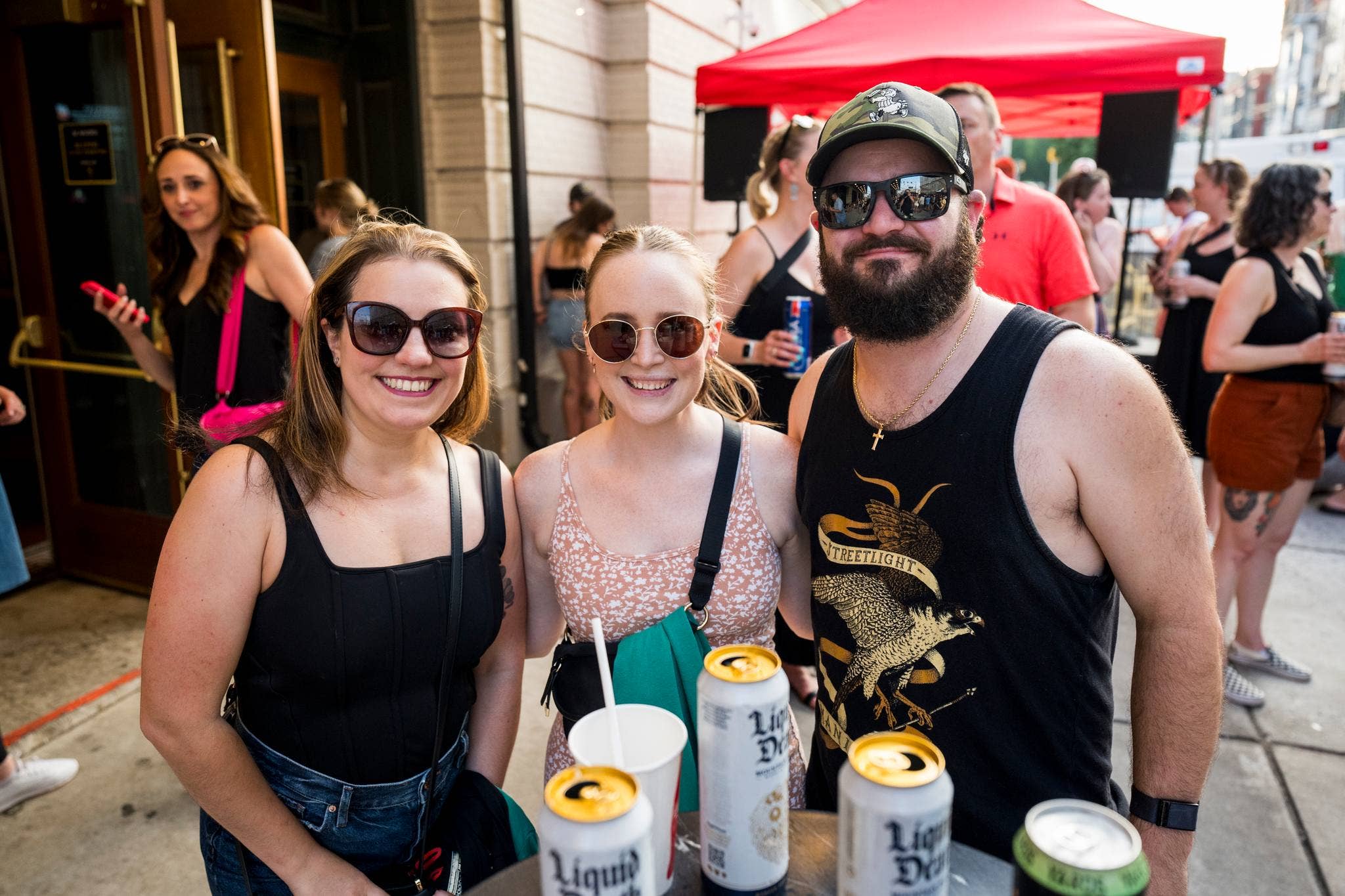 Three people facing the camera and smiling