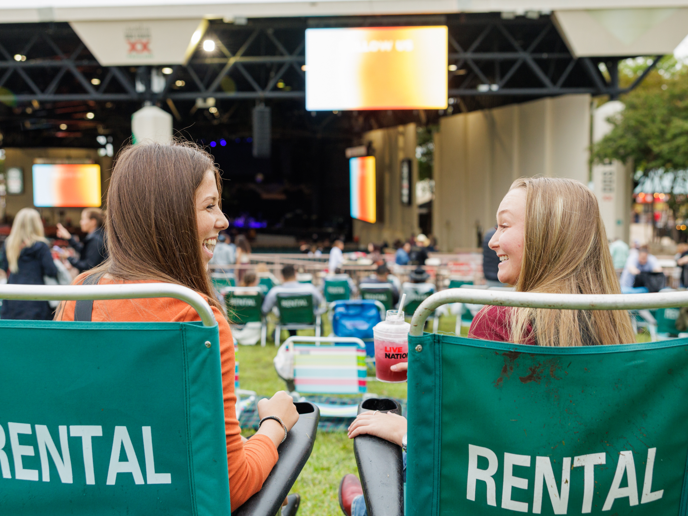 Two people sitting in lawn chairs.