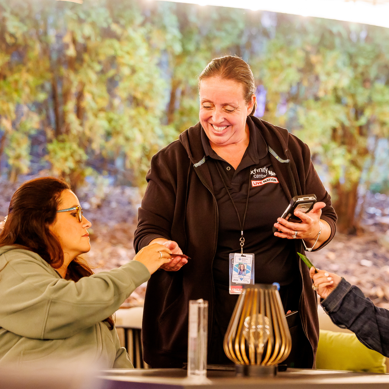 a smiling VIP Concierge taking two women's orders